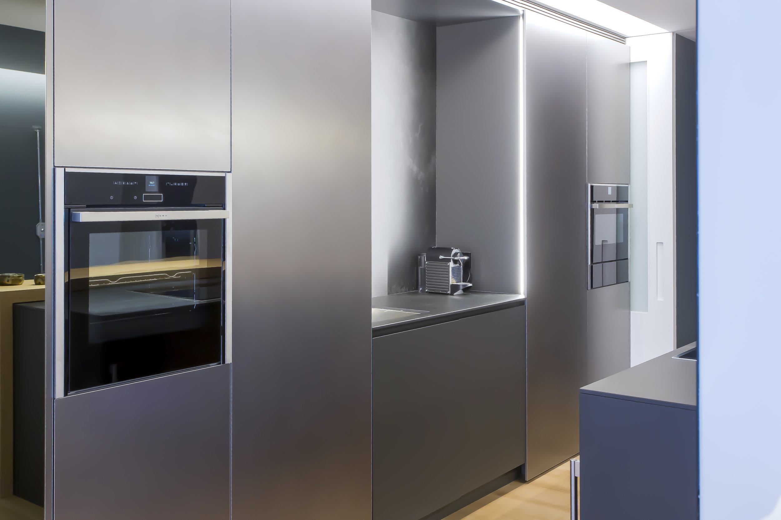 Metallic finish kitchen cabinets with oven and sink