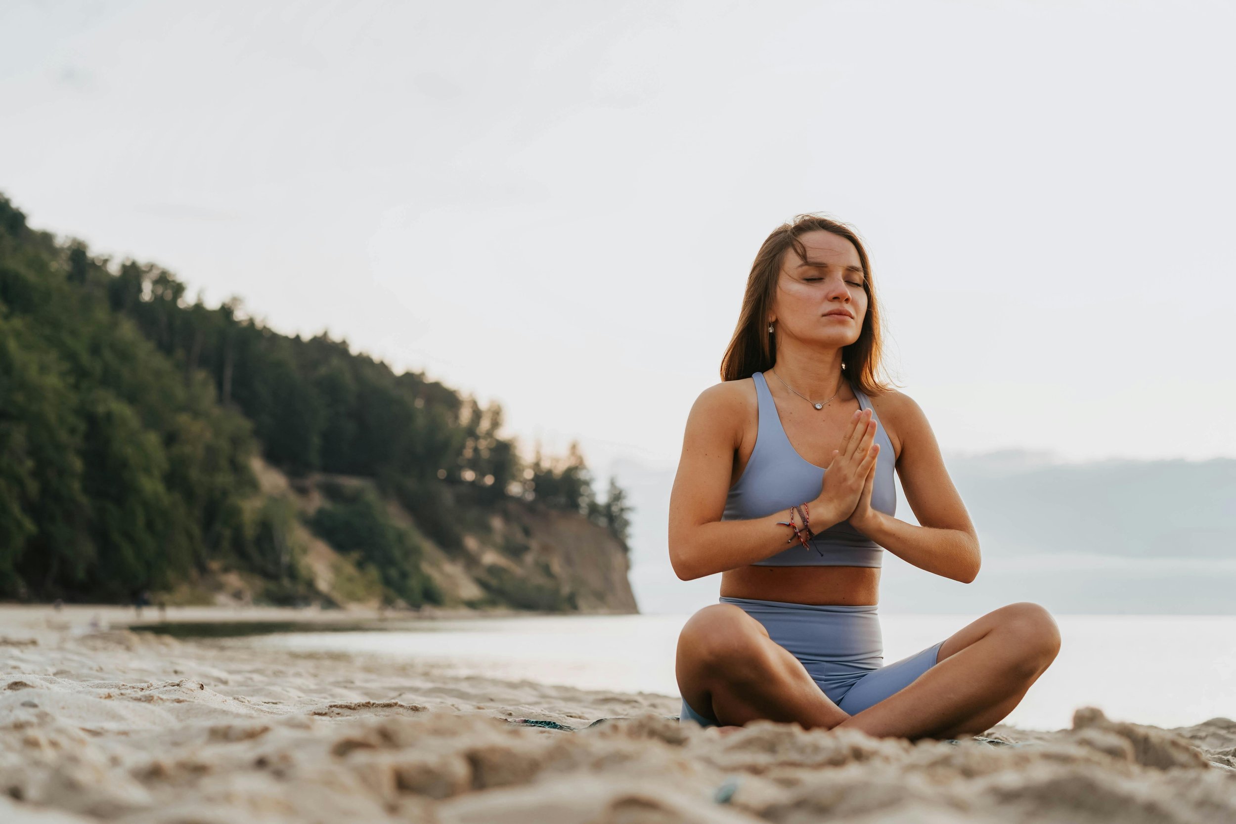 Women meditating on beach ADHD
