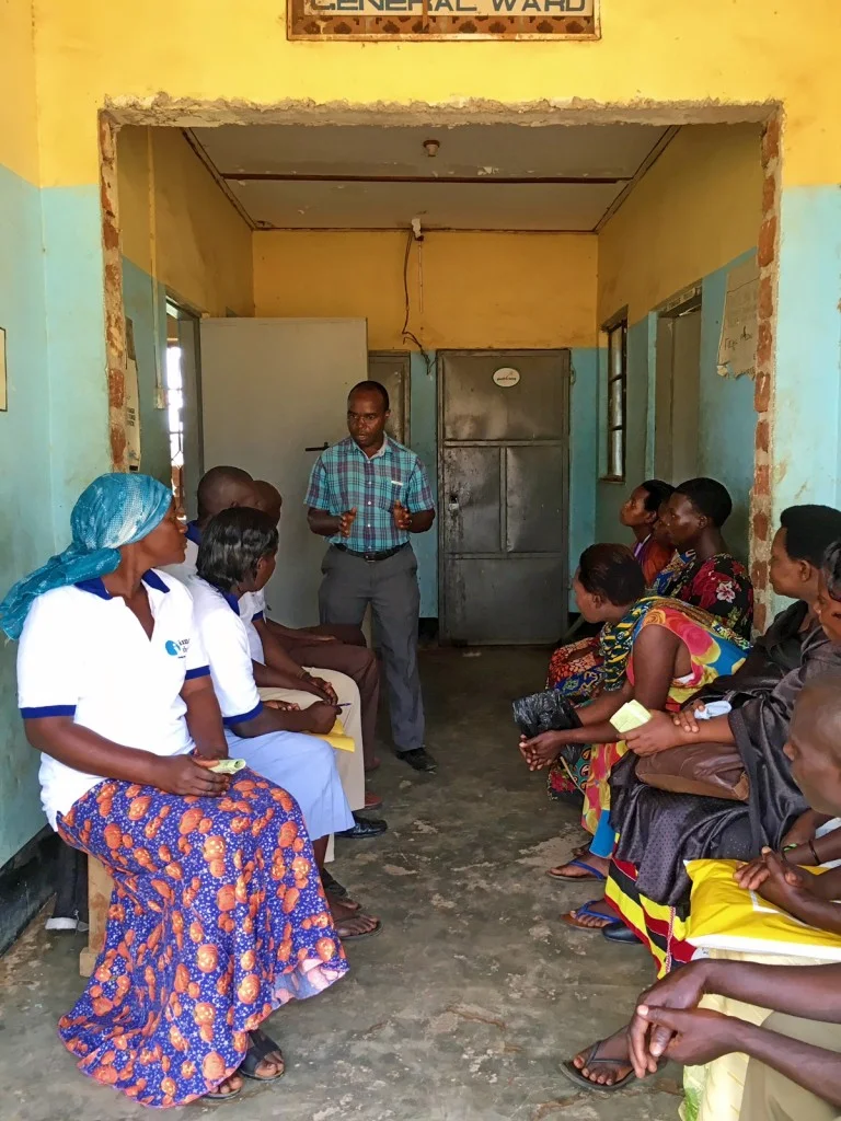 Dr. Alphons Matovu speaks with VHTs at Kasambya Health Center III about the RHD program.