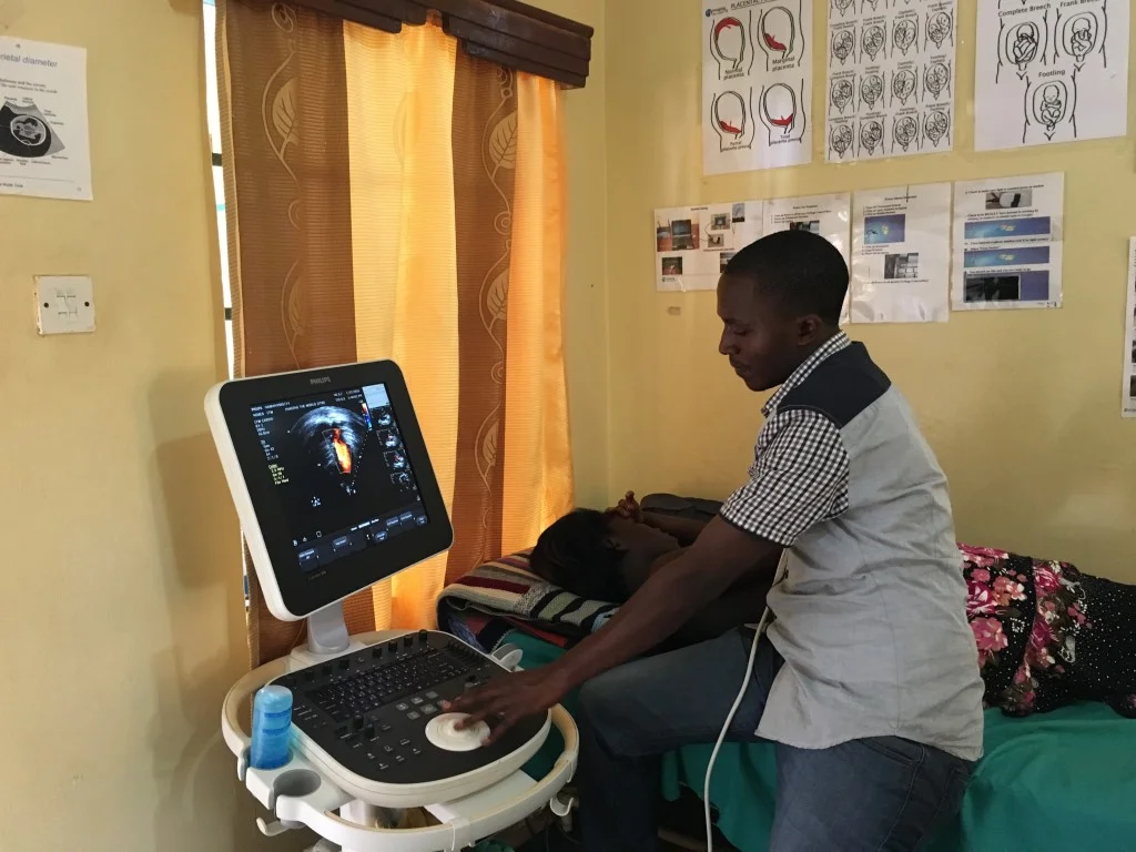 Moses doing an echocardiogram. Note we are able to use the same ultrasound system that we use for OB and other scans; just a different transducer.