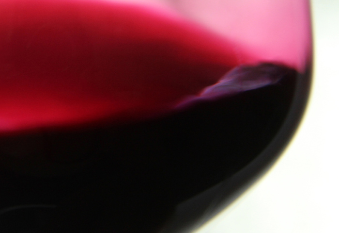 Close look at a swirl of red wine.