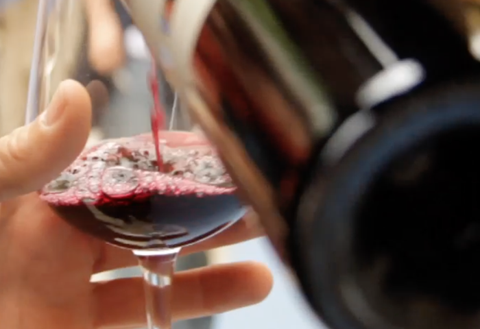 Wine being poured into a glass.
