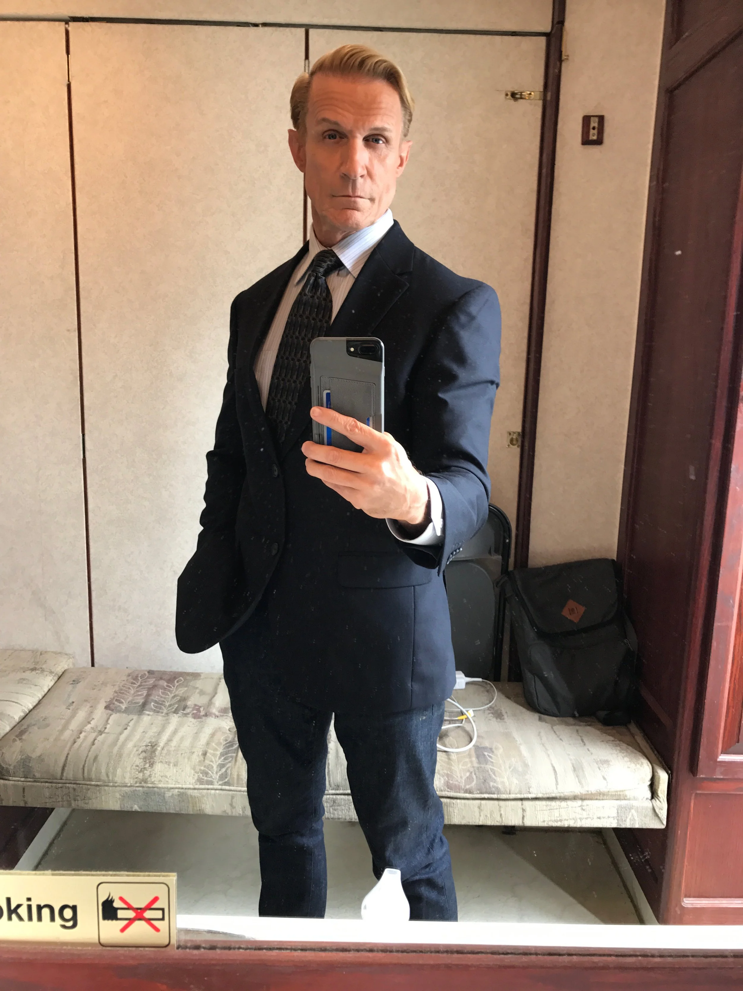 Clay in his trailer on set in a suit.JPG