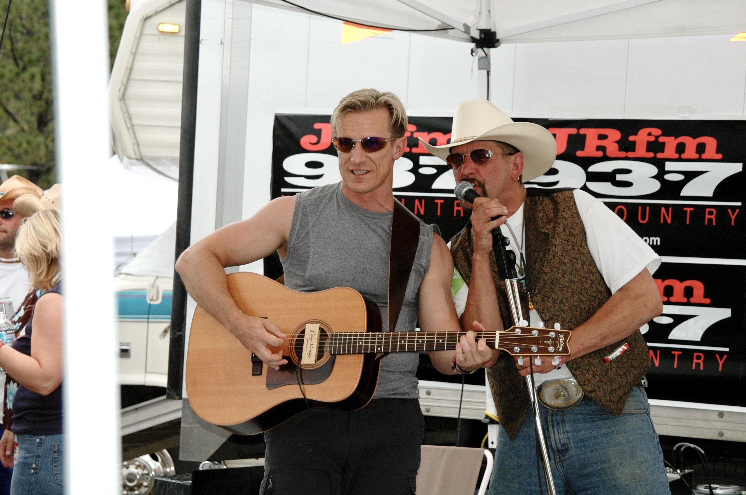 Clay St. Thomas playing guitar at a radio station event.jpeg