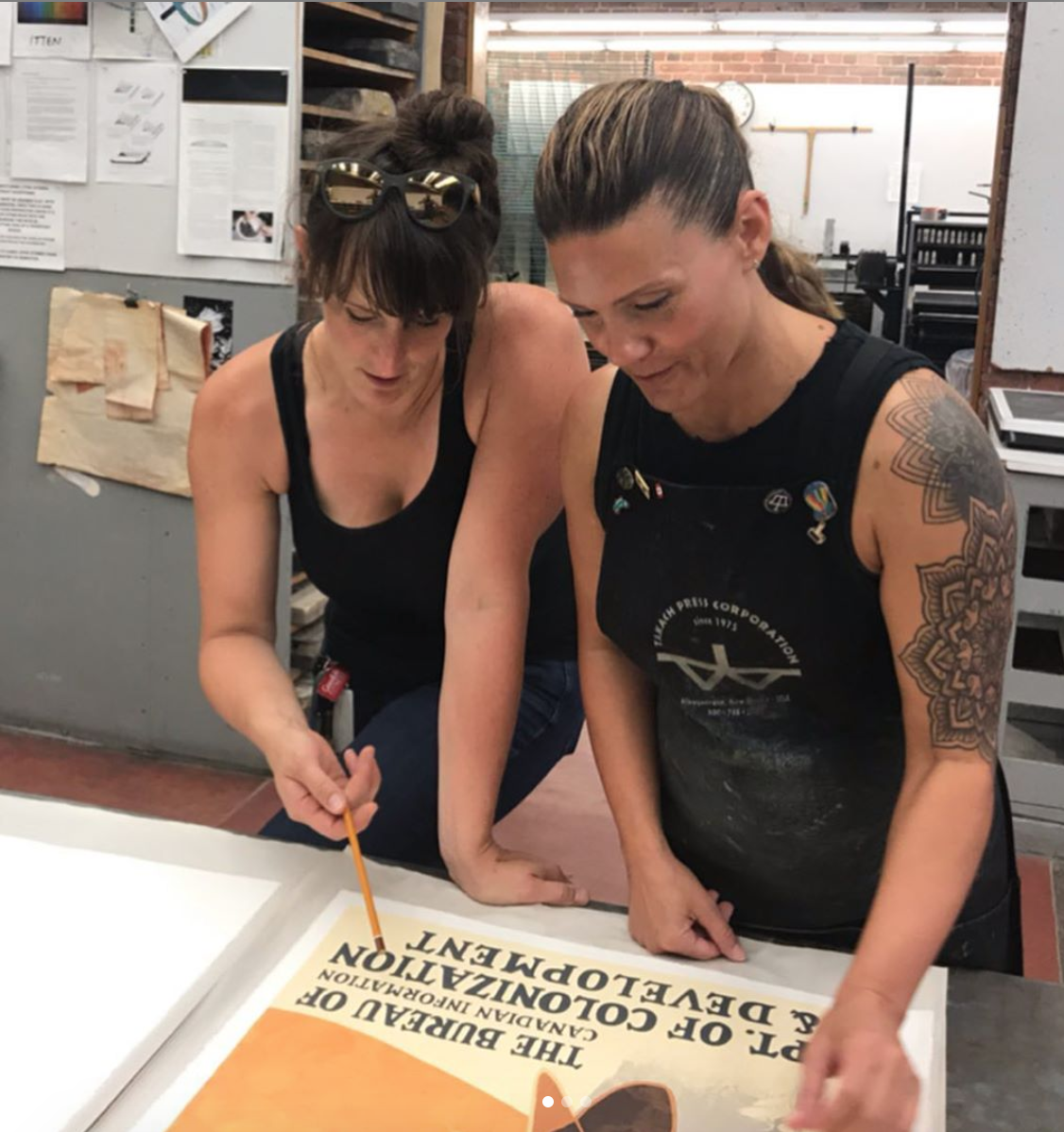 Jill Graham with Ericka Walker who is signing off on a lithograph.