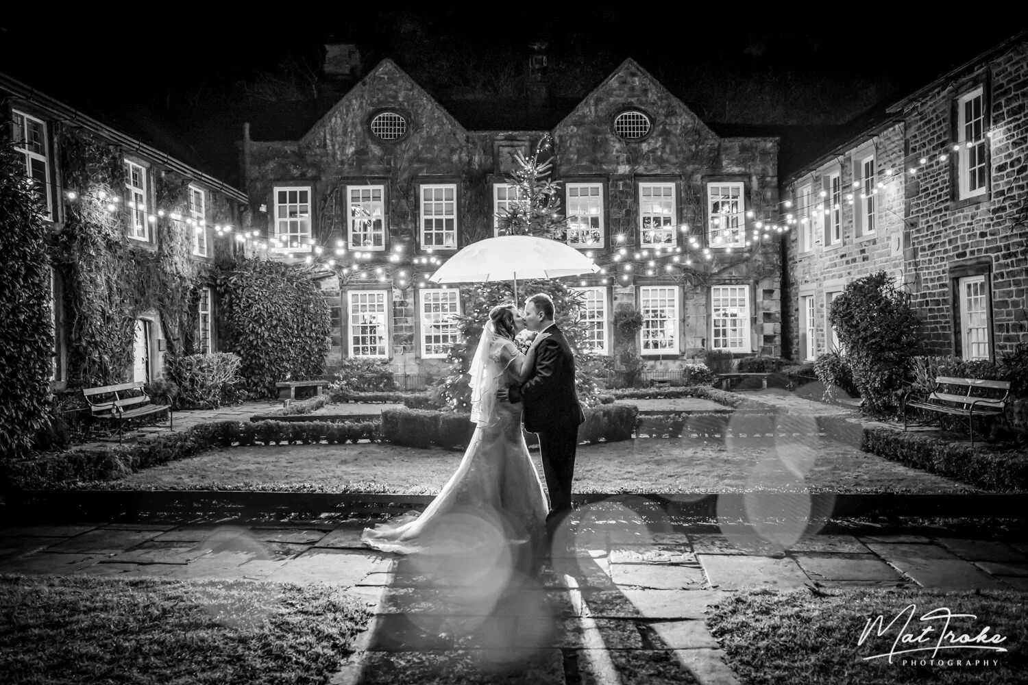 Whitley Hall Sheffield, Christmas December wedding umbrella kiss in rain with flash photography