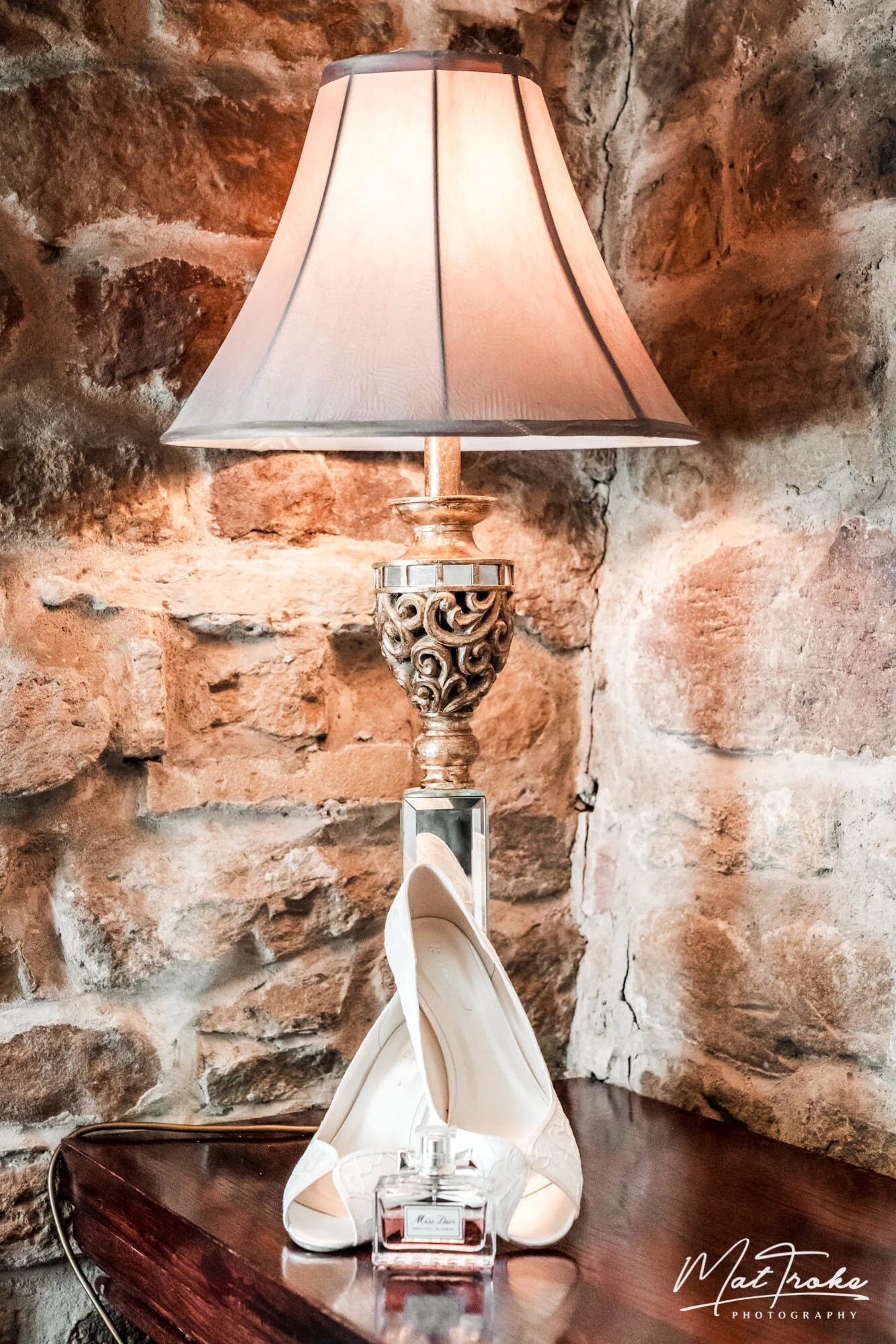 Xmas wedding bridal preparation heels and perfume in hotel bar at Whitley