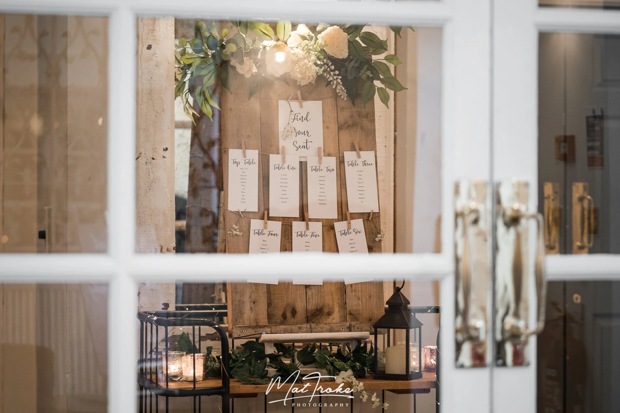 Wedding breakfast venue dressing in The Folly with table plan and flowers ready for speeches