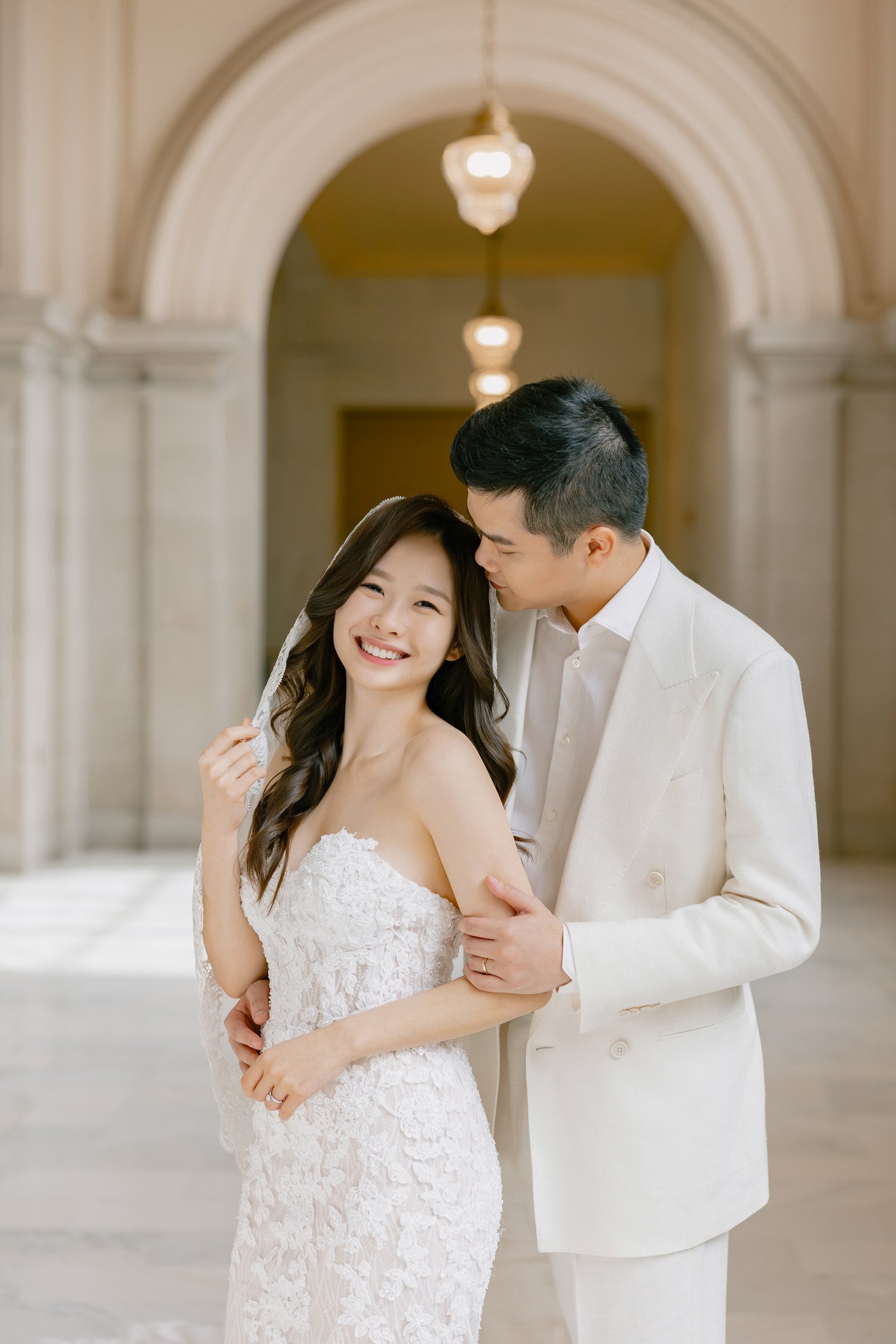 Couple portrait in the arched corridor at San Francisco City Hall, photographed by Vivi Lin Photography