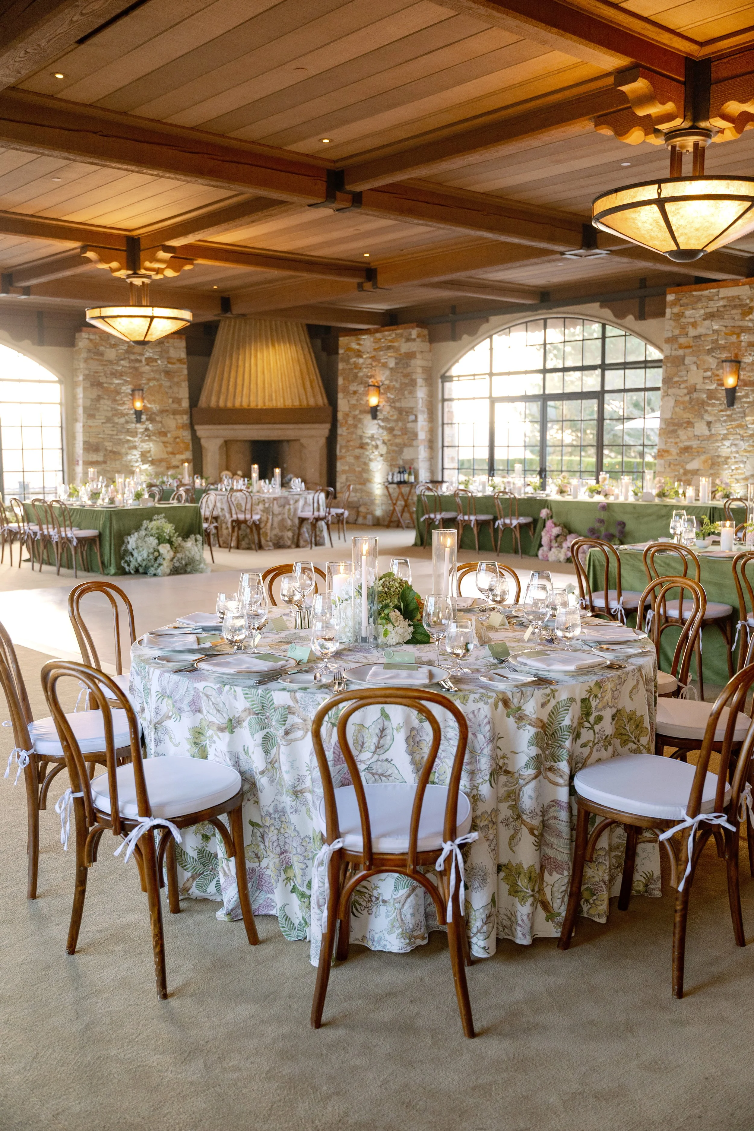 Aerial view of an elegant outdoor wedding ceremony at a Napa Valley winery surrounded by vineyards and olive trees.