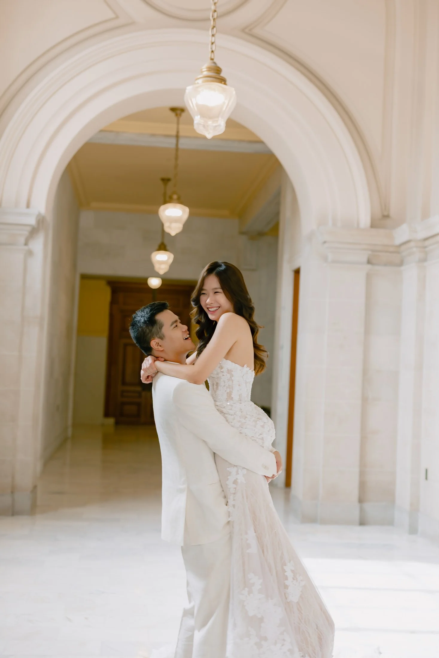 Couple laughing and embracing at San Francisco City Hall, photographed by Vivi Lin Photography