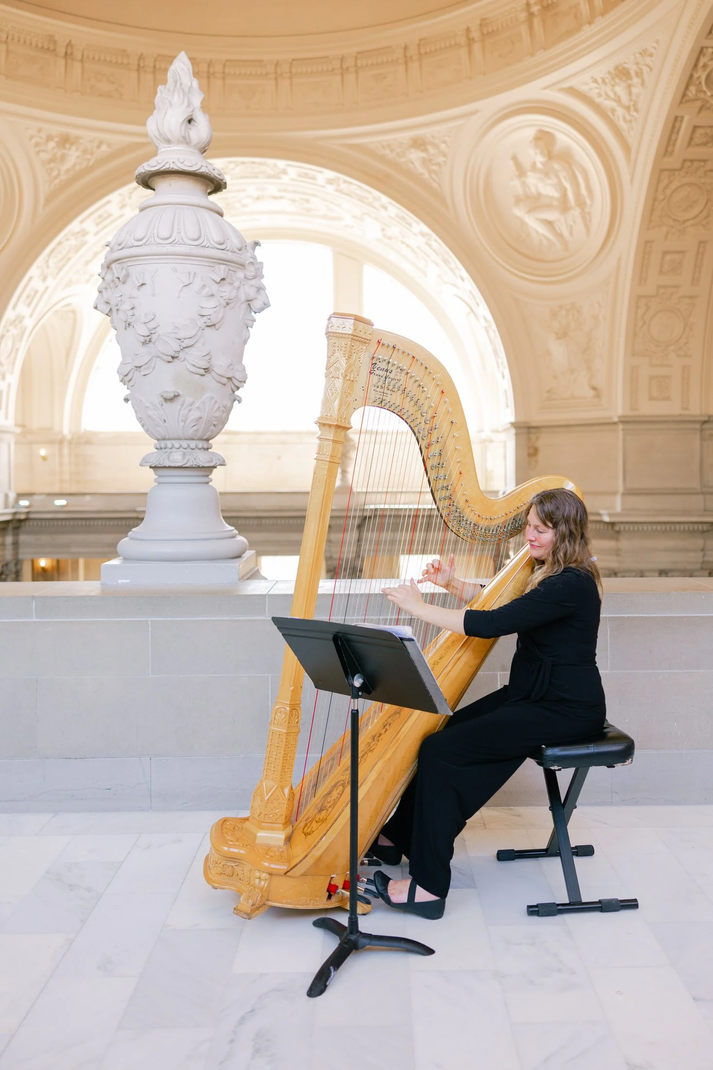 Harpist performing during a wedding ceremony at San Francisco City Hall rotunda