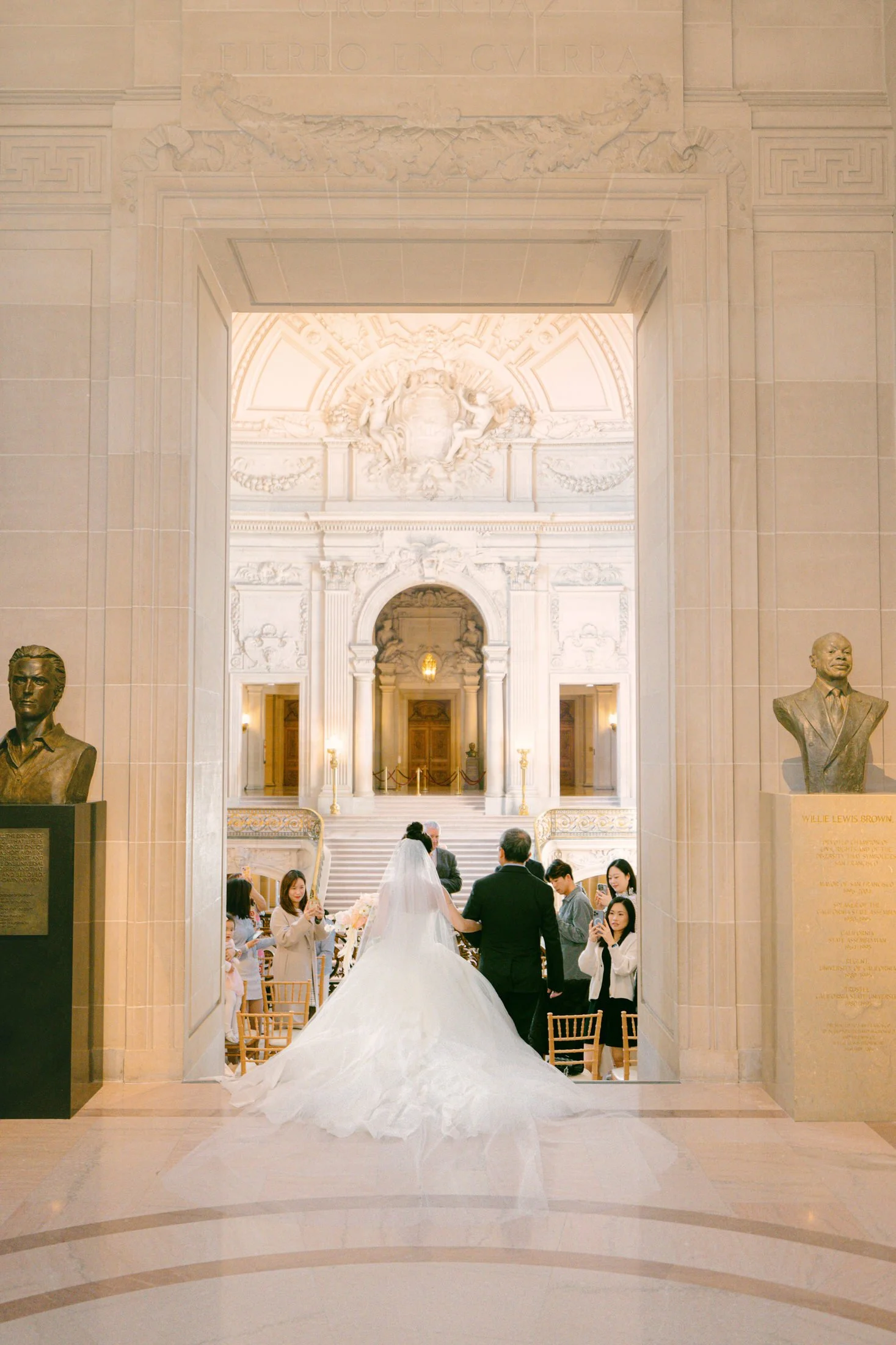 Bride walking into her wedding ceremony on the Mayor's Balcony at San Francisco City Hall second floor