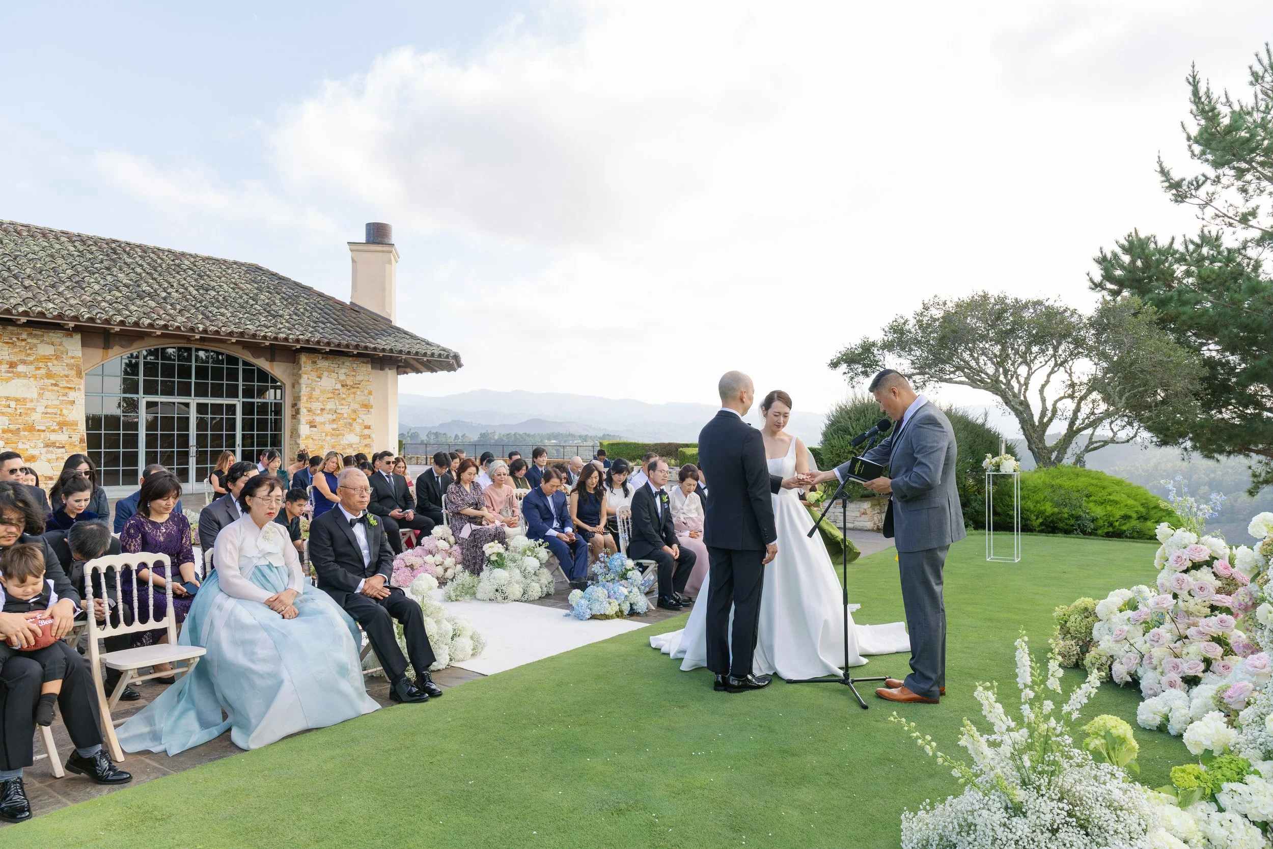 Bride and groom exchanging vows during an outdoor wedding ceremony at Tehama Golf Club in Carmel, California