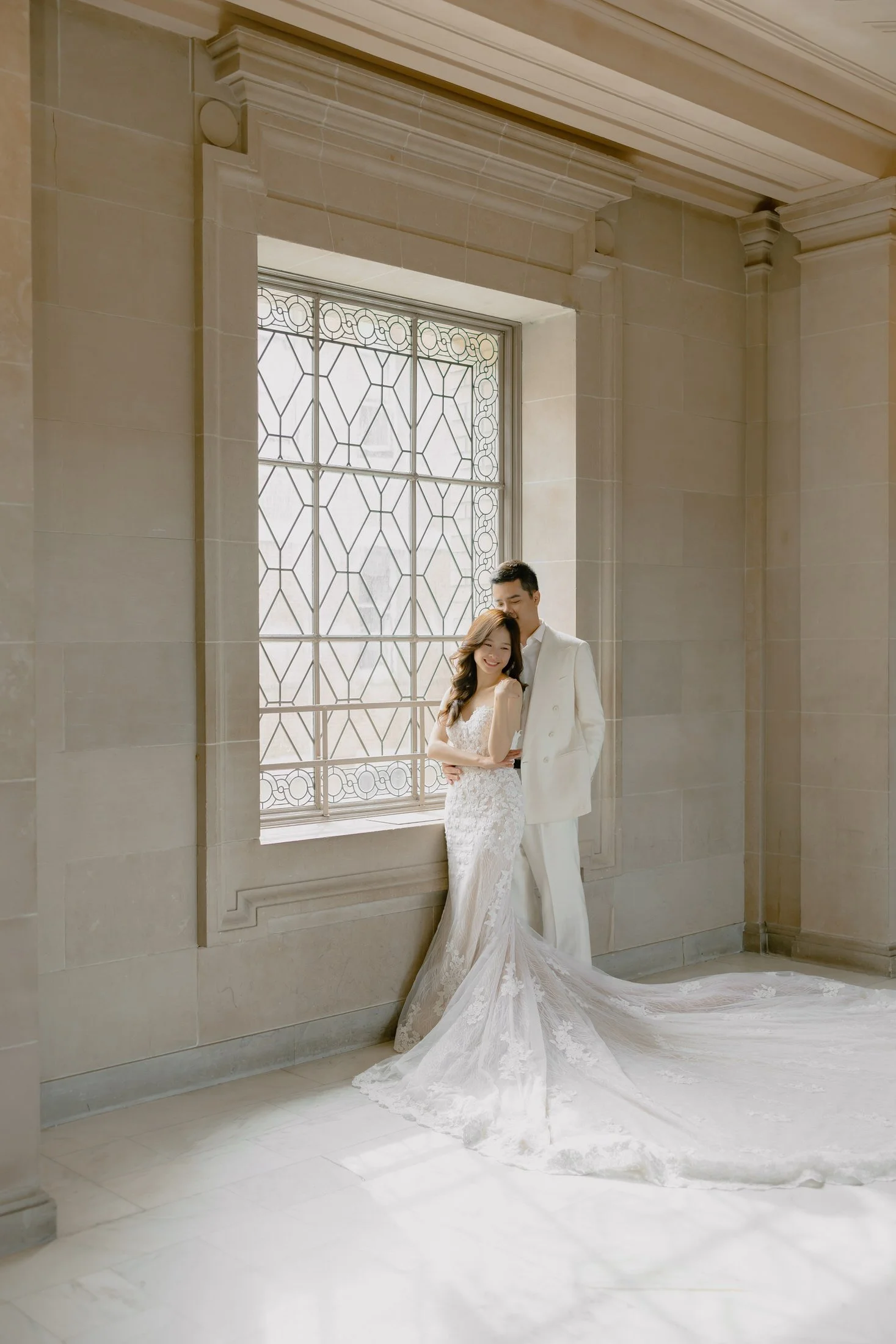 Bride and groom in soft window light during their SF City Hall elopement