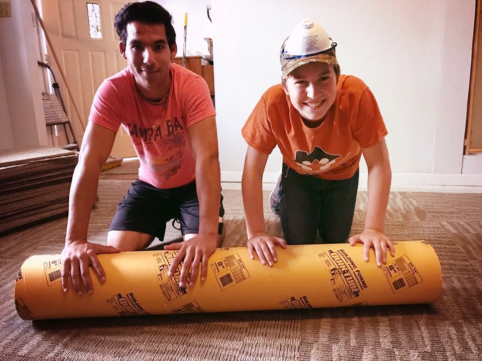 Nathan rolling out carpet.jpg