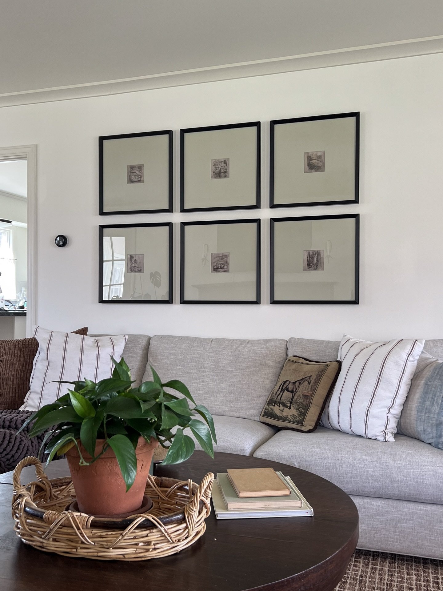 I brought these gallery frames with me when we moved from Queens, and it took me two years to put them up 🙃

Once I did, the white mats felt way too stark in the living room, so I painted them!

I mixed up some acrylic paint to get this muddy green-