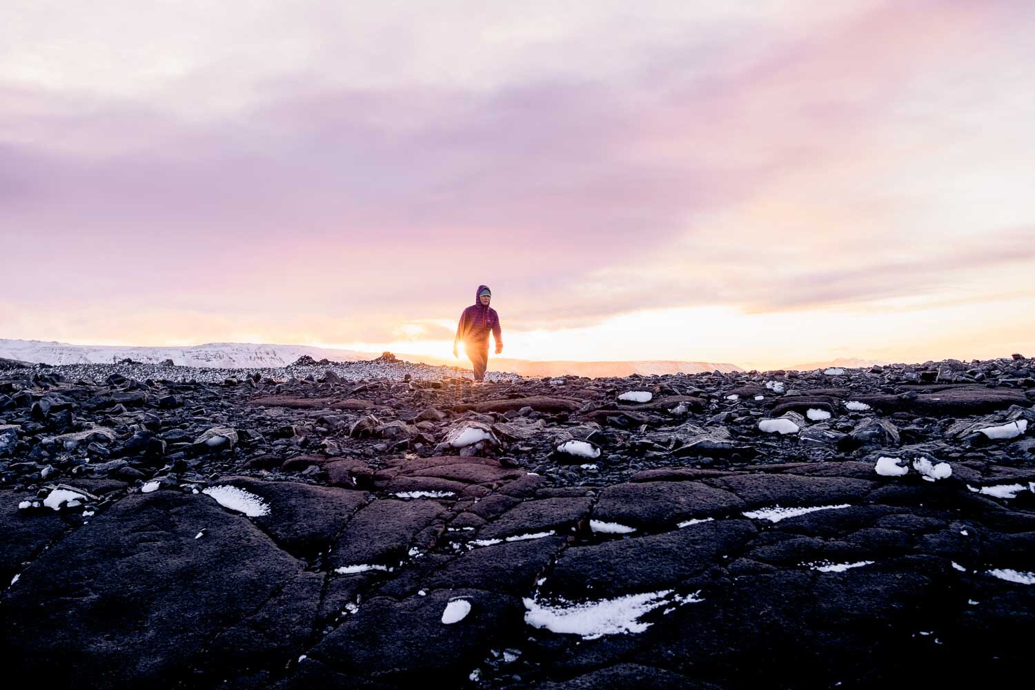 A woman hiking in Iceland's vast nature in winter in the Capital Region.