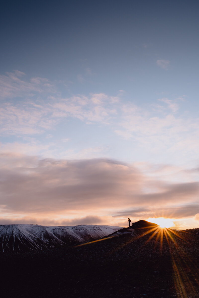 A hiker taking a rest on Mt. Helgafell, Capital Region of Iceland.