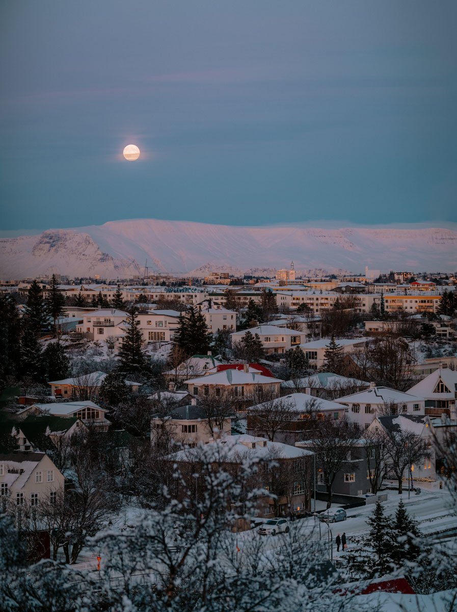 The moon shines over Mt. Esja in Reykjavik, winter, Iceland