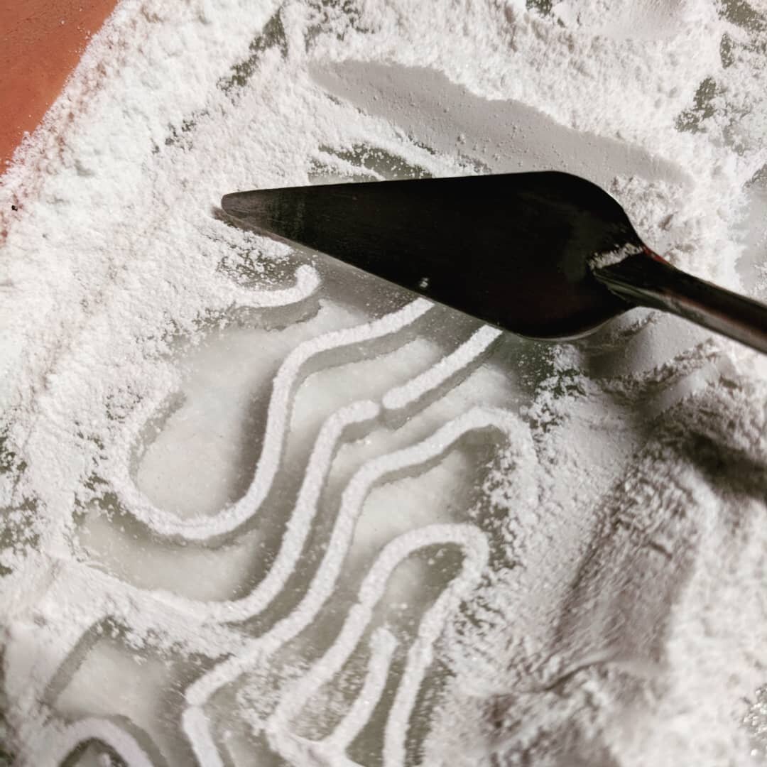 Filling the slits of my waterjet cut drawing with enamel white powder.  In previous experiments you have to really push the powder down to the bottom of the channels otherwise you get a patchy line,. I'm not sure how far I managed this time with a pa