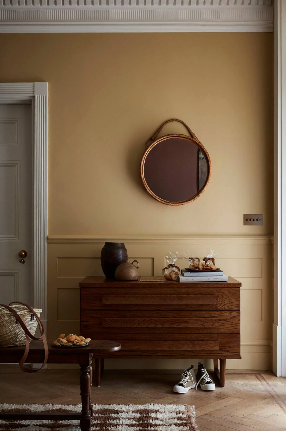 Warm neutral interior by Little Greene with plaster-toned walls, wooden console table and soft beige and clay colour palette