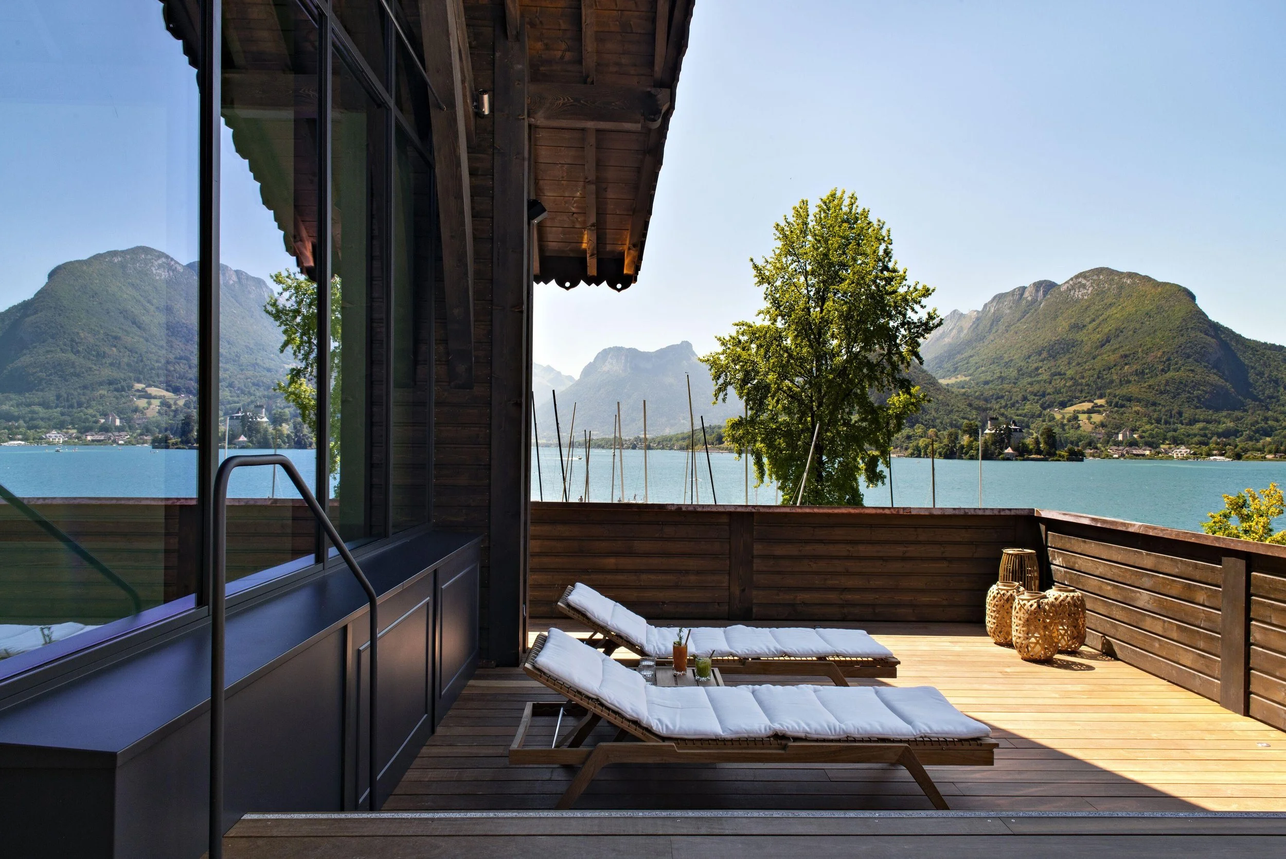Private lakeside terrace at Auberge du Père Bise with panoramic views across Lake Annecy