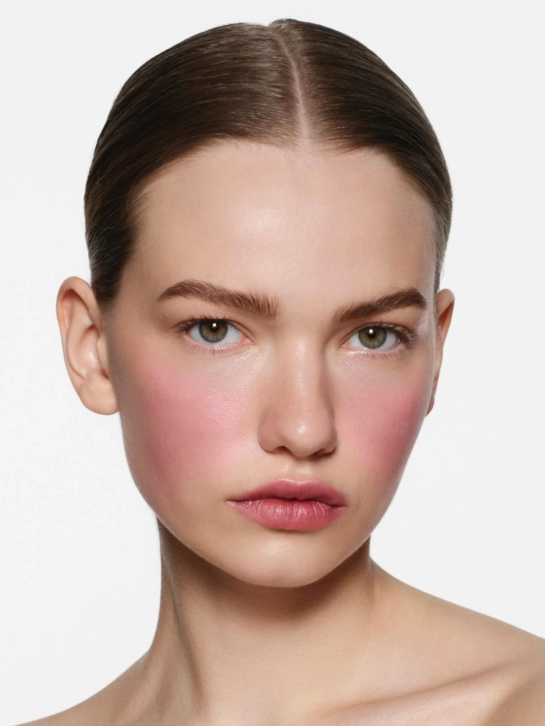 Victoria Beckham Beauty campaign featuring windswept pink blush across the cheeks.