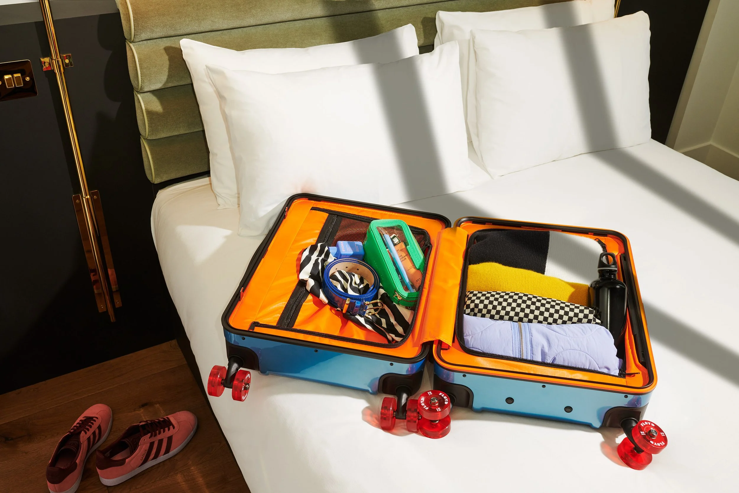  Suitcase opened up on bed at Tribe Hotel Canary Wharf, London. 