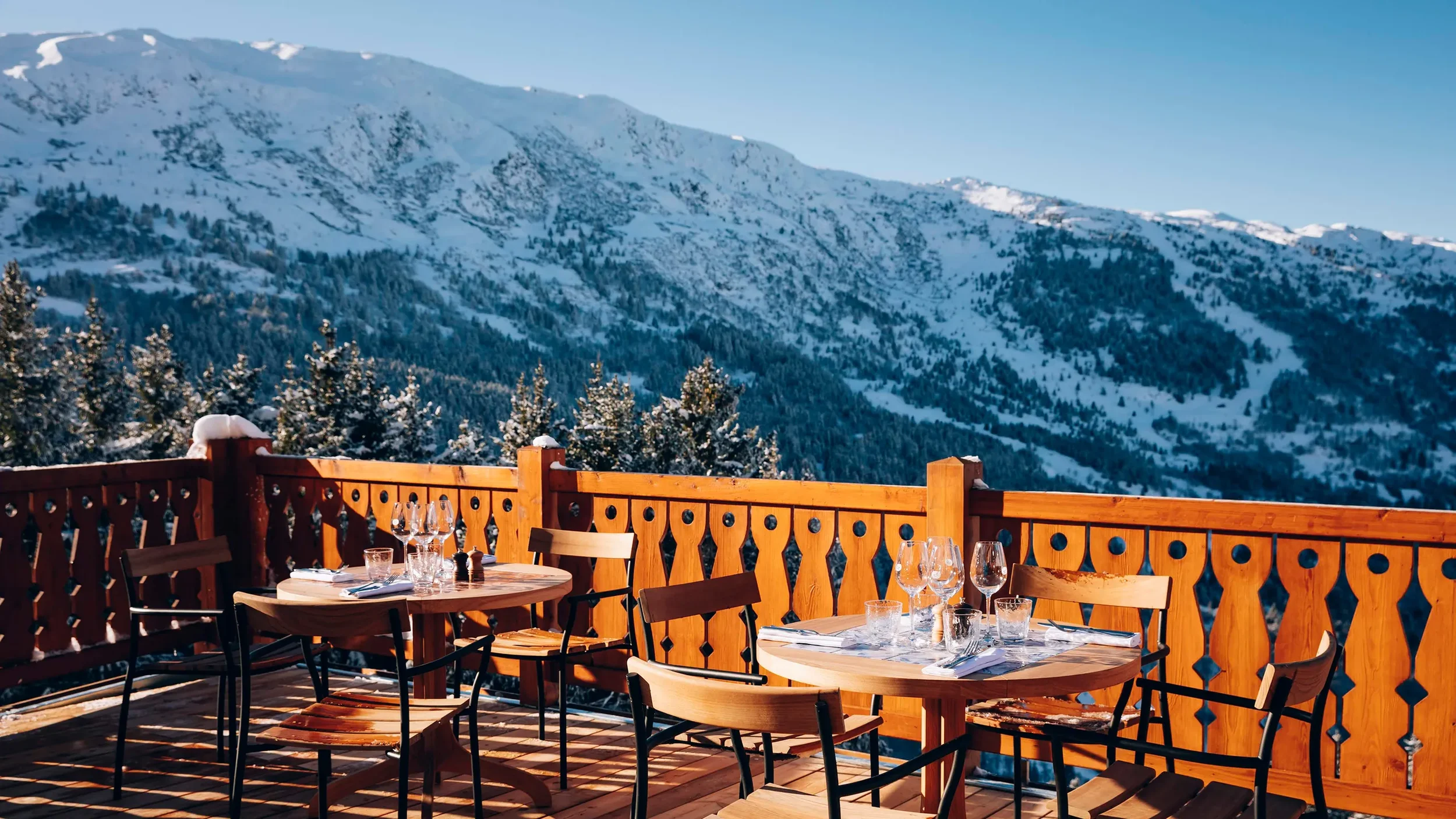 Table set up for lunch over looking the Alps on balcony of Le Coucou Meribel, France