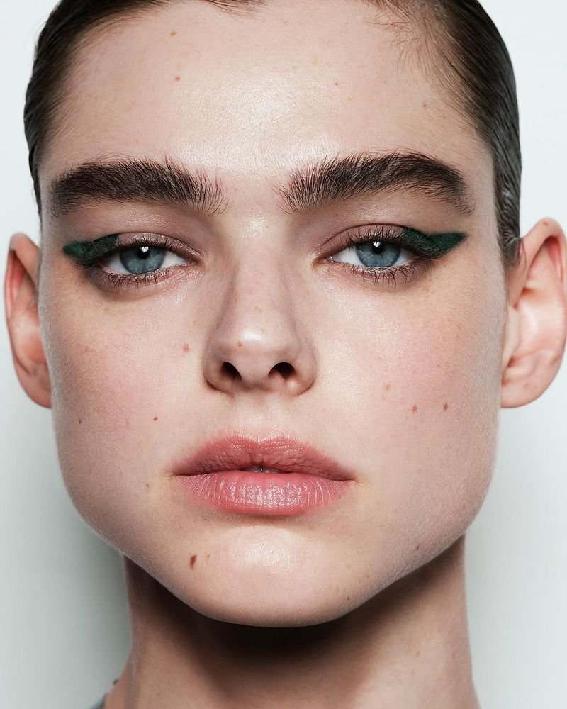 Victoria Beckham Beauty model wearing bold emerald-green winged eyeliner.