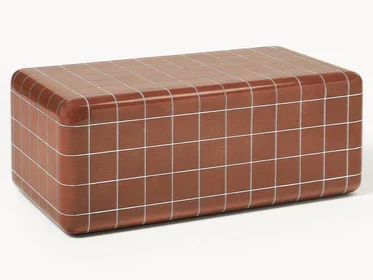 Curved tiled coffee table in warm brown tones with grid pattern inspired by 90s interior design