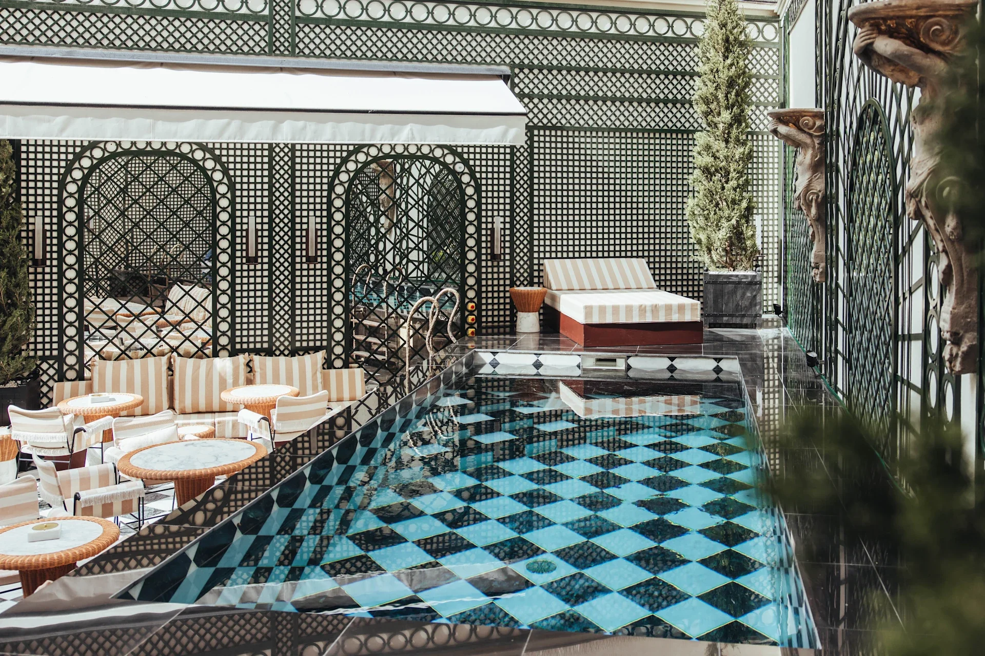 Outdoor swimming pool and dining area at Sax Paris LXR