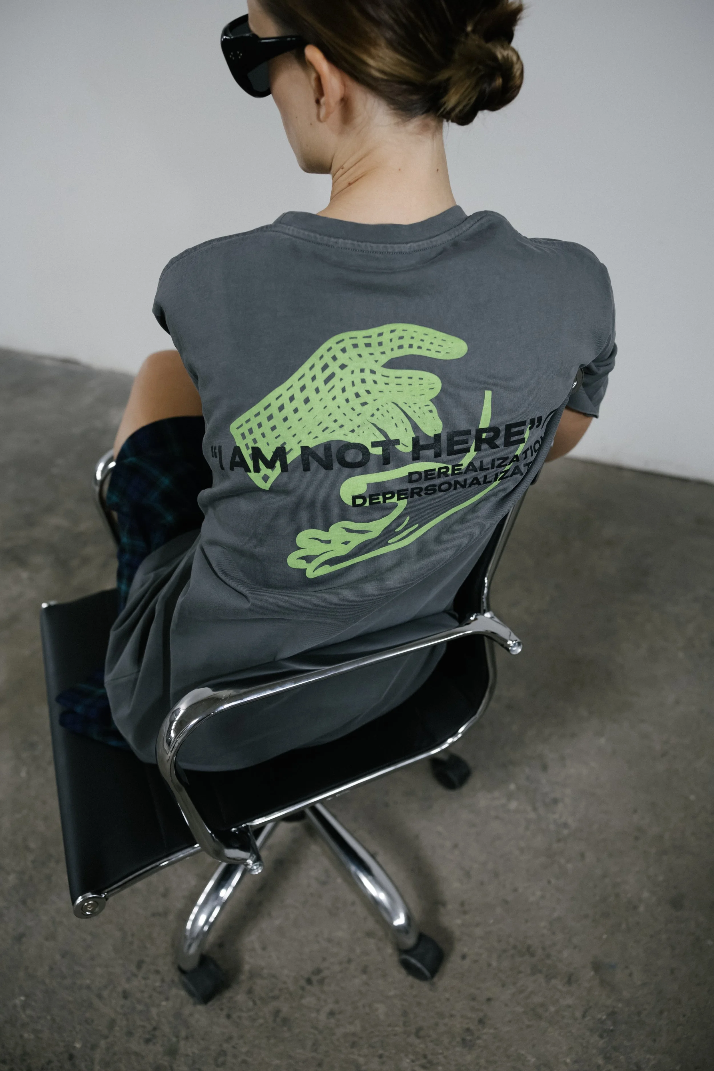 Back of 11:11 LUCK graphic T-shirt featuring “I Am Not Here” slogan artwork