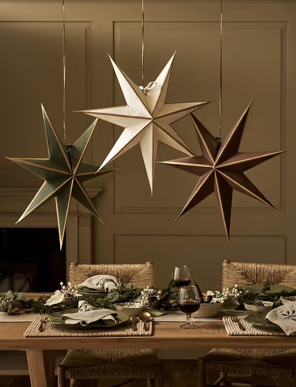 Garden Trading hanging star Christmas decorations above a festive dining table