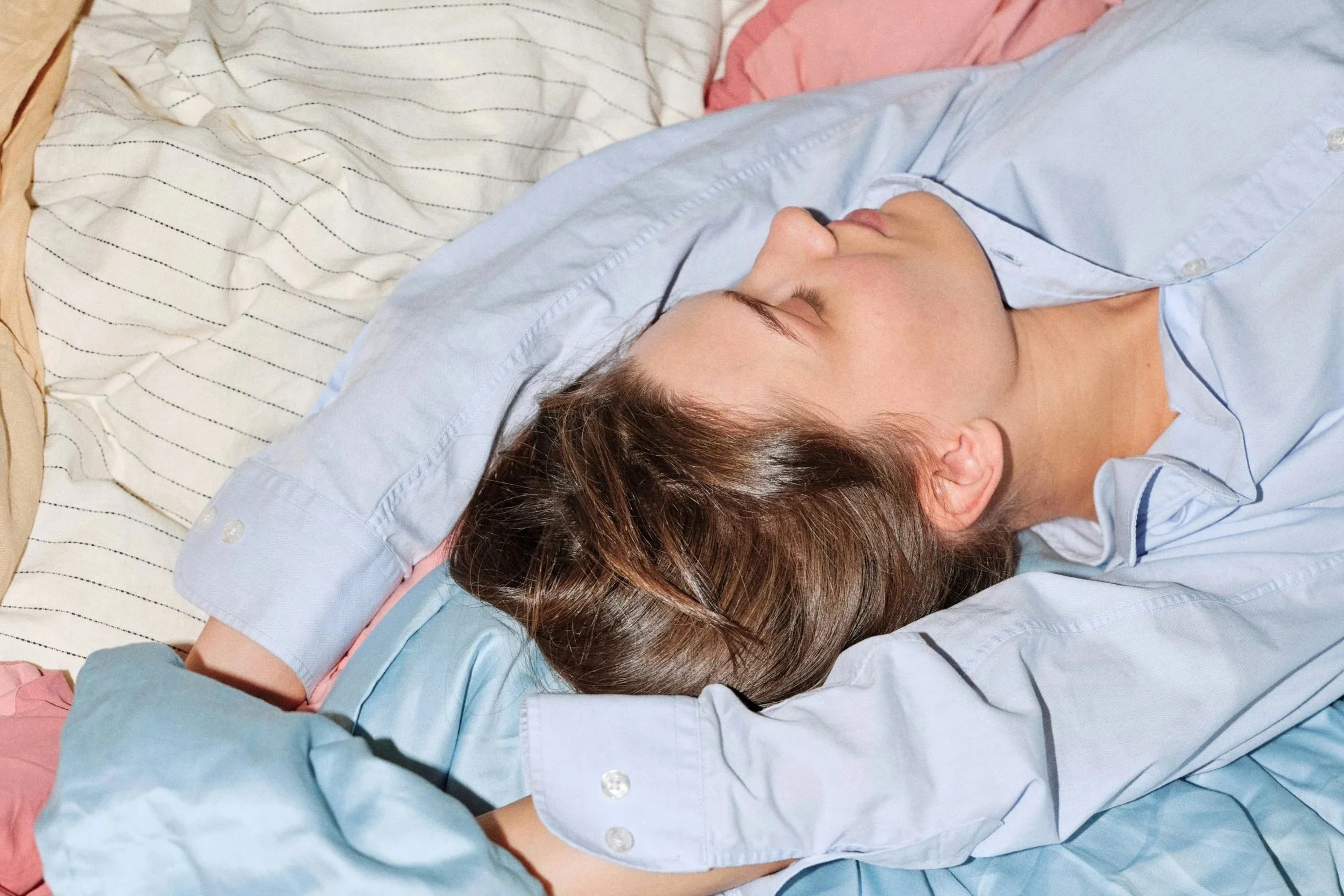 Woman resting with her eyes closed, illustrating L-theanine’s potential benefits for relaxation and sleep
