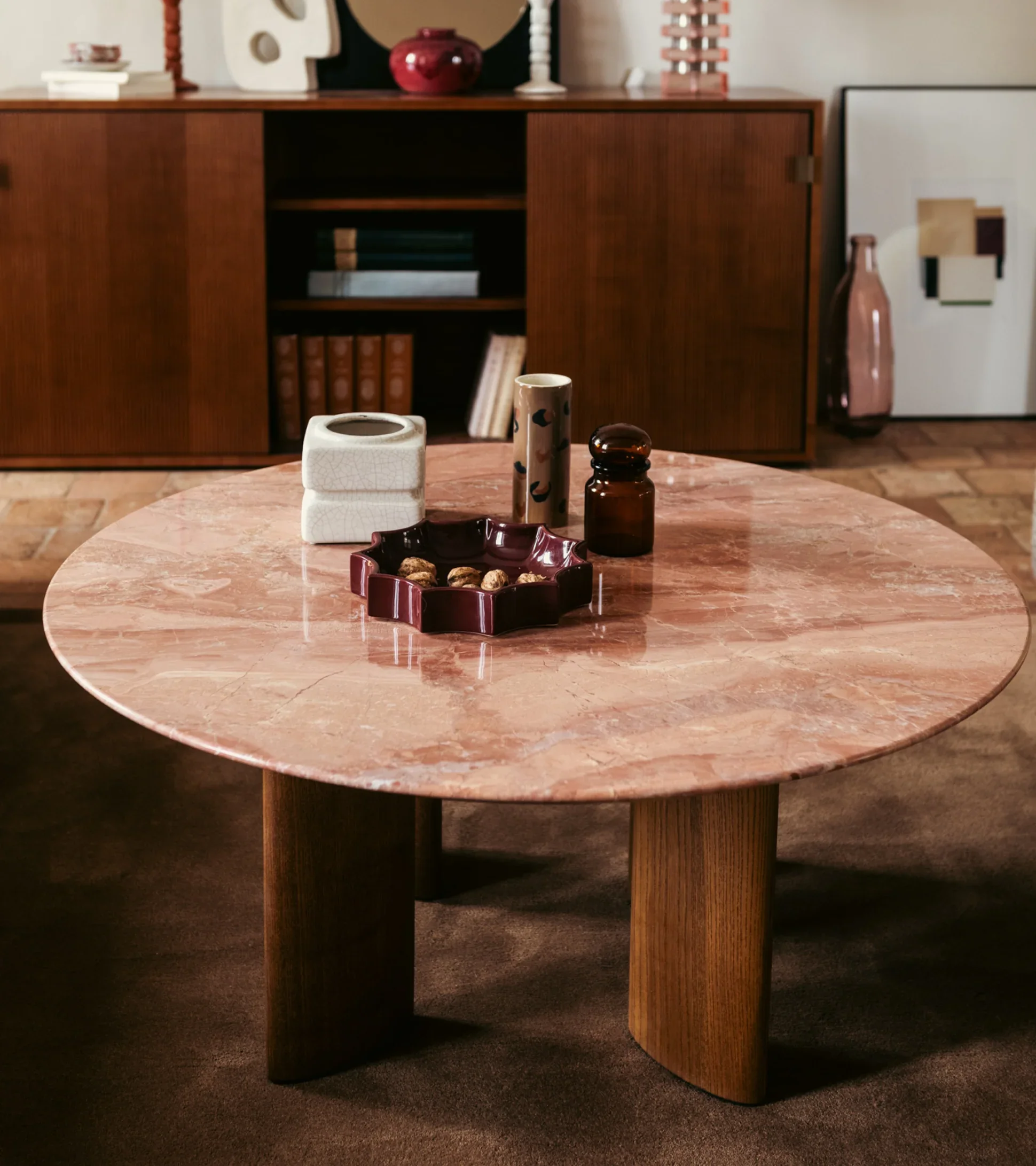 The Socialite Family Carlotta Coffee Table . Round pink marble coffee table with curved wooden legs, adding warmth and softness to a modern living space
