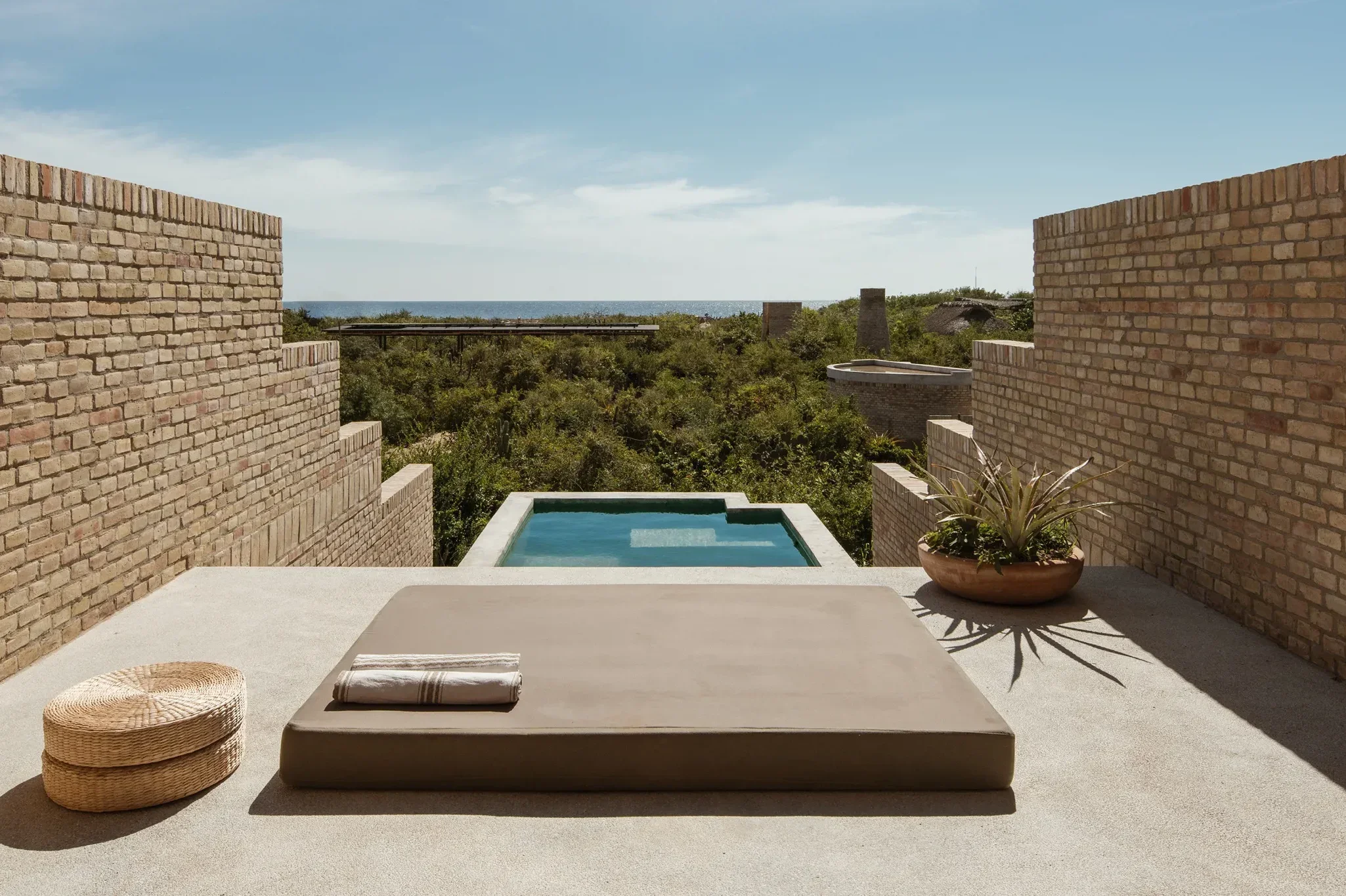 Concrete terrace and plunge pool at Hotel Terrestre overlooking the Pacific coastline near Puerto Escondido, Mexico