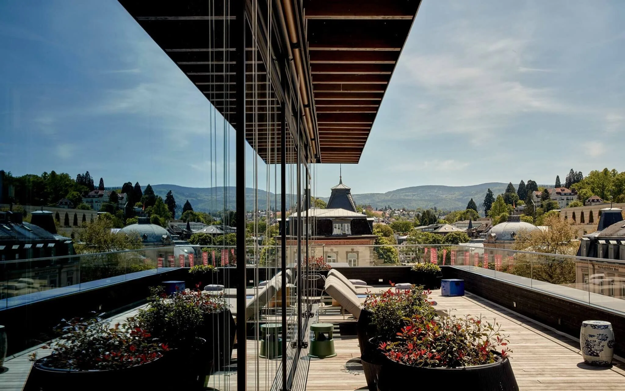 Contemporary rooftop terrace at Roomers Baden-Baden hotel overlooking the Black Forest region in Germany.
