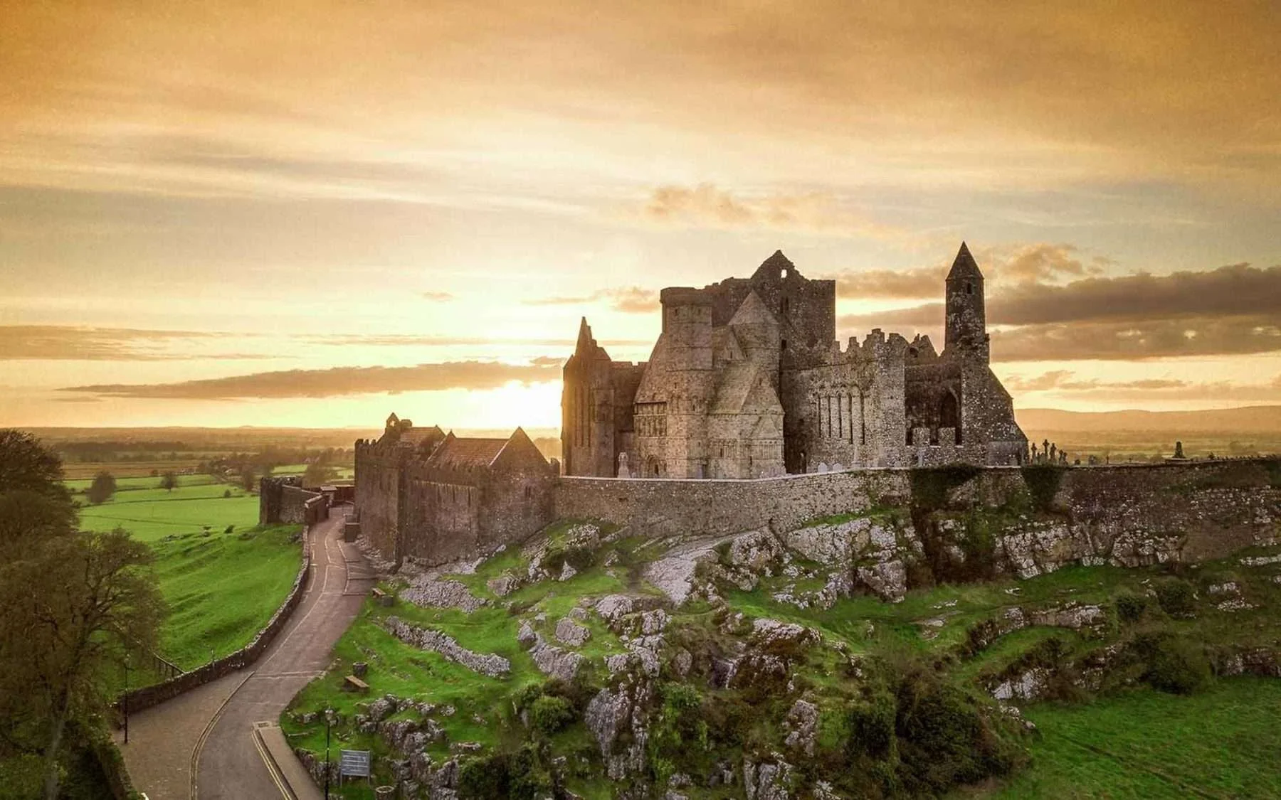 Rock of Cashel, surrounded by green fields at sunset, Ireland