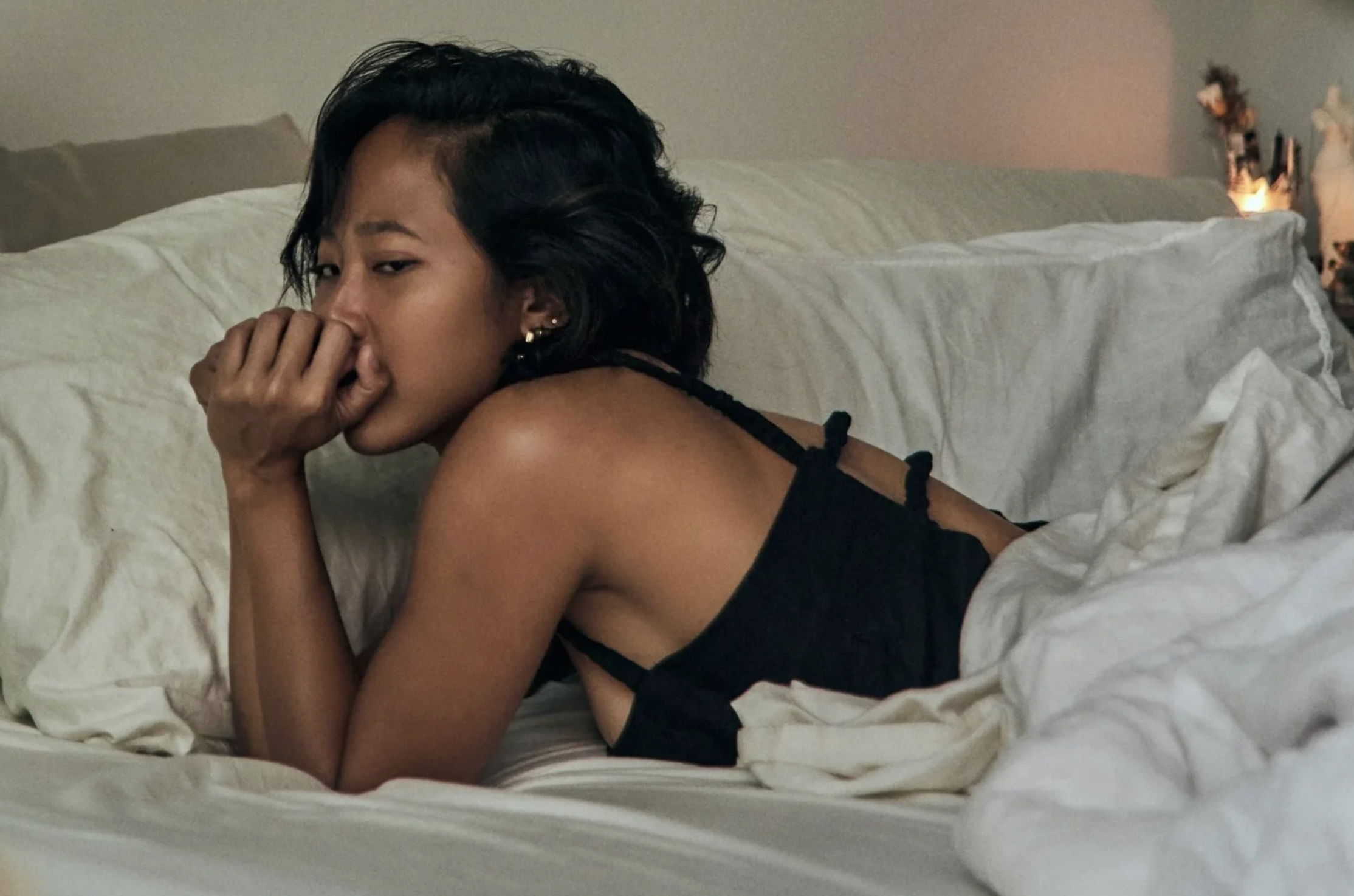 Woman awake at night in bed, representing 3am waking and sleep disruption