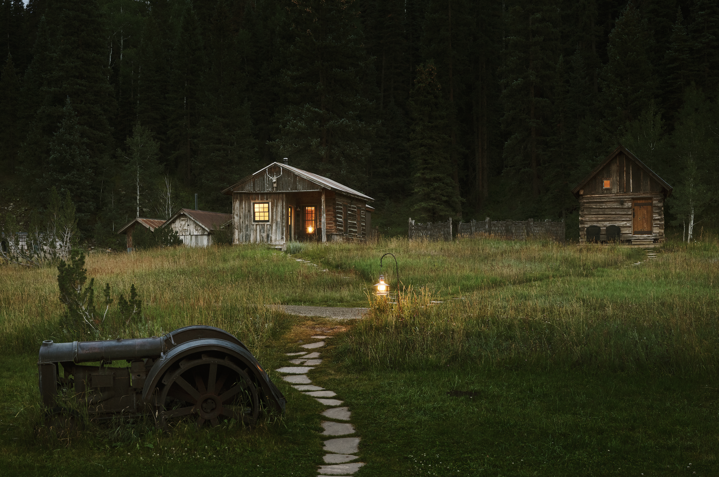 Historic log cabins at dusk in the meadow at Dunton Hot Springs, Colorado