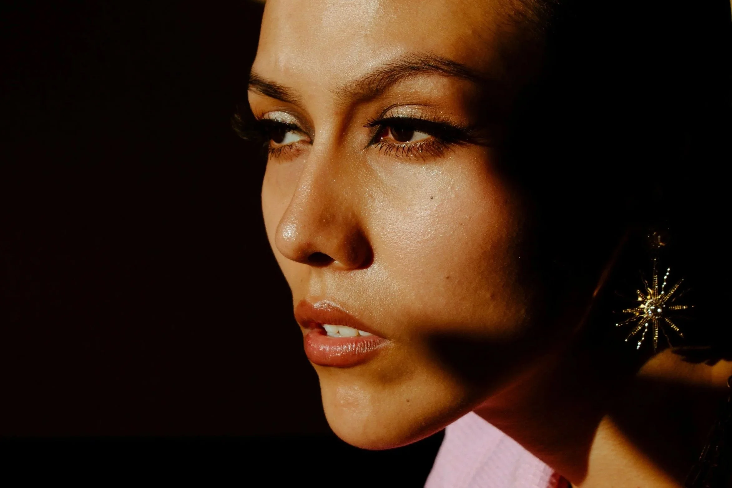 Close-up portrait in soft shadow highlighting subtle changes in facial definition and skin structure