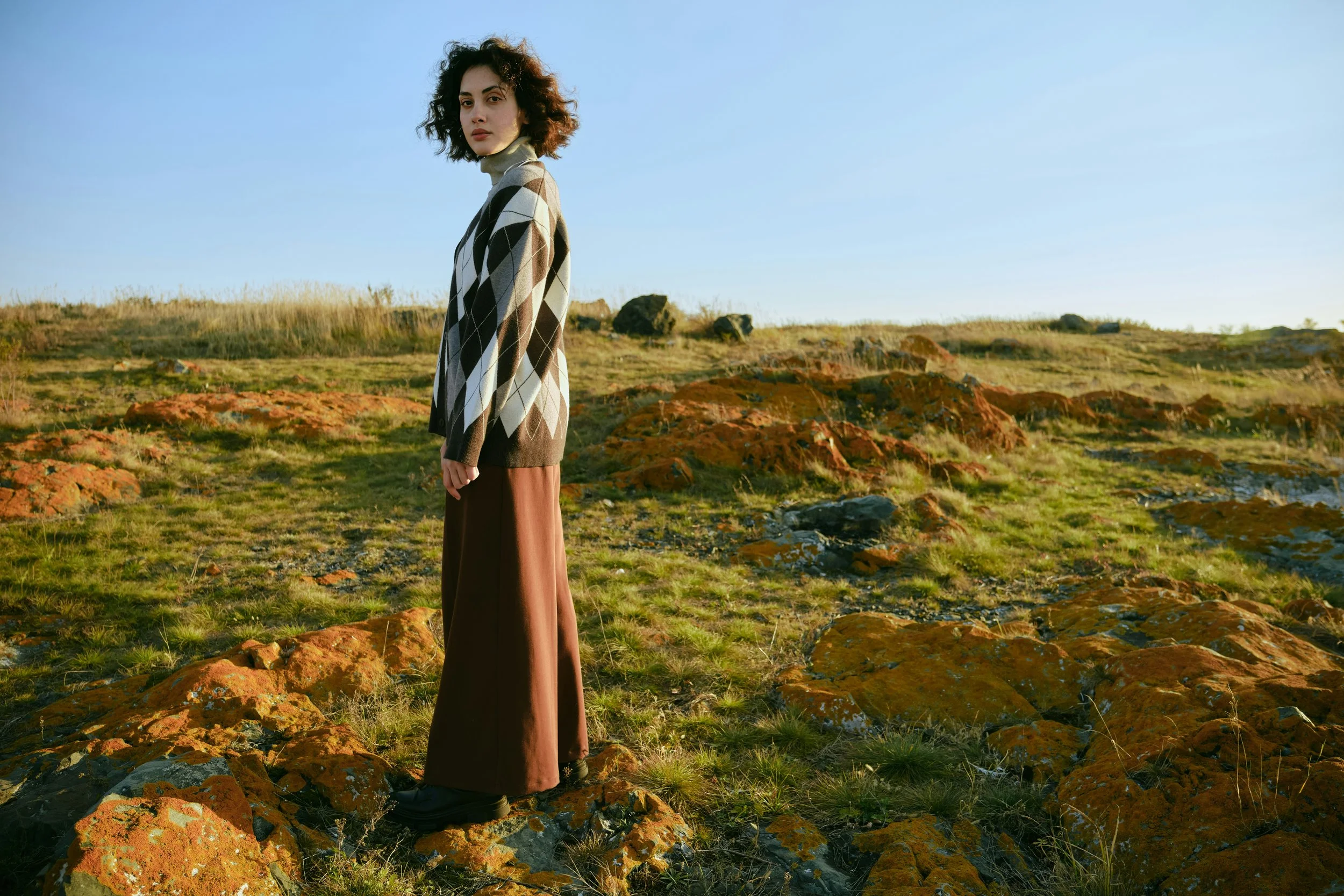 Woman standing in an open landscape, representing perspective, clarity and long-term wellbeing