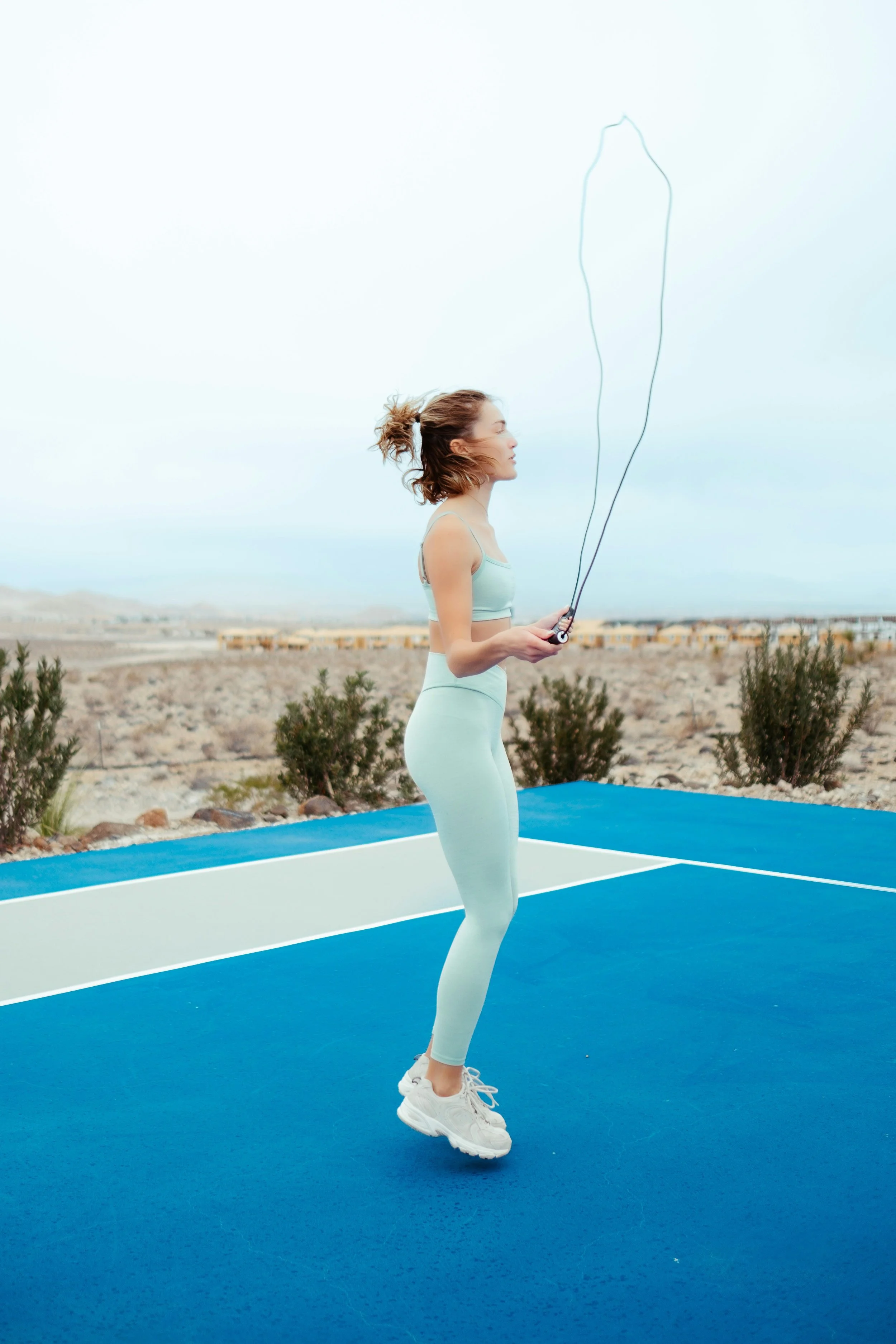 Woman skipping outdoors during a cardio workout to support strength, fitness and healthy ageing.