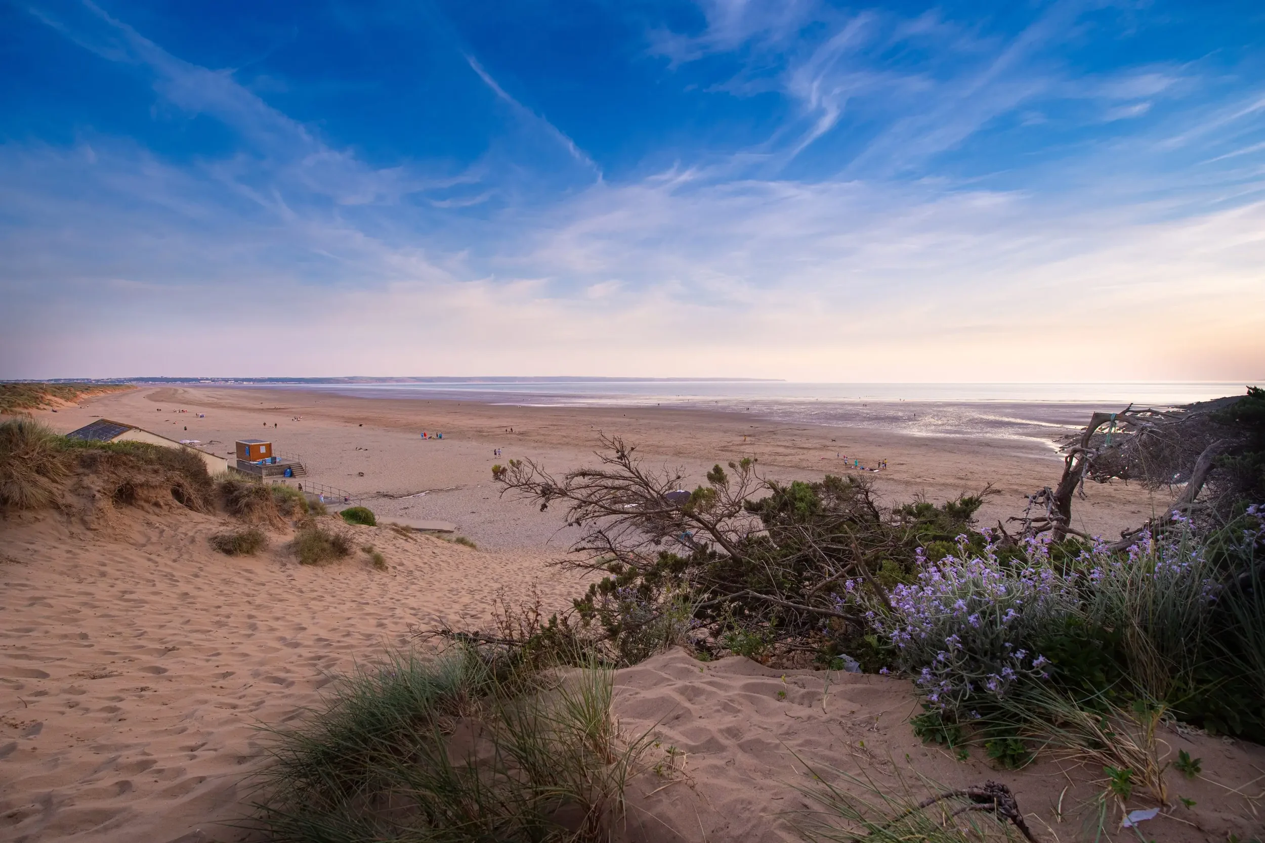 Saunton Sands in Devon with vast golden beach, rolling dunes and expansive coastal views.