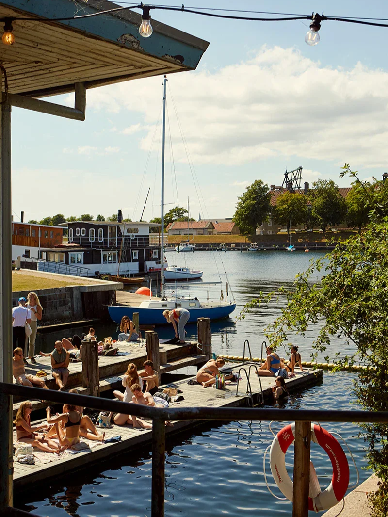 Colourful waterfront buildings lining Nyhavn harbour in Copenhagen during summer