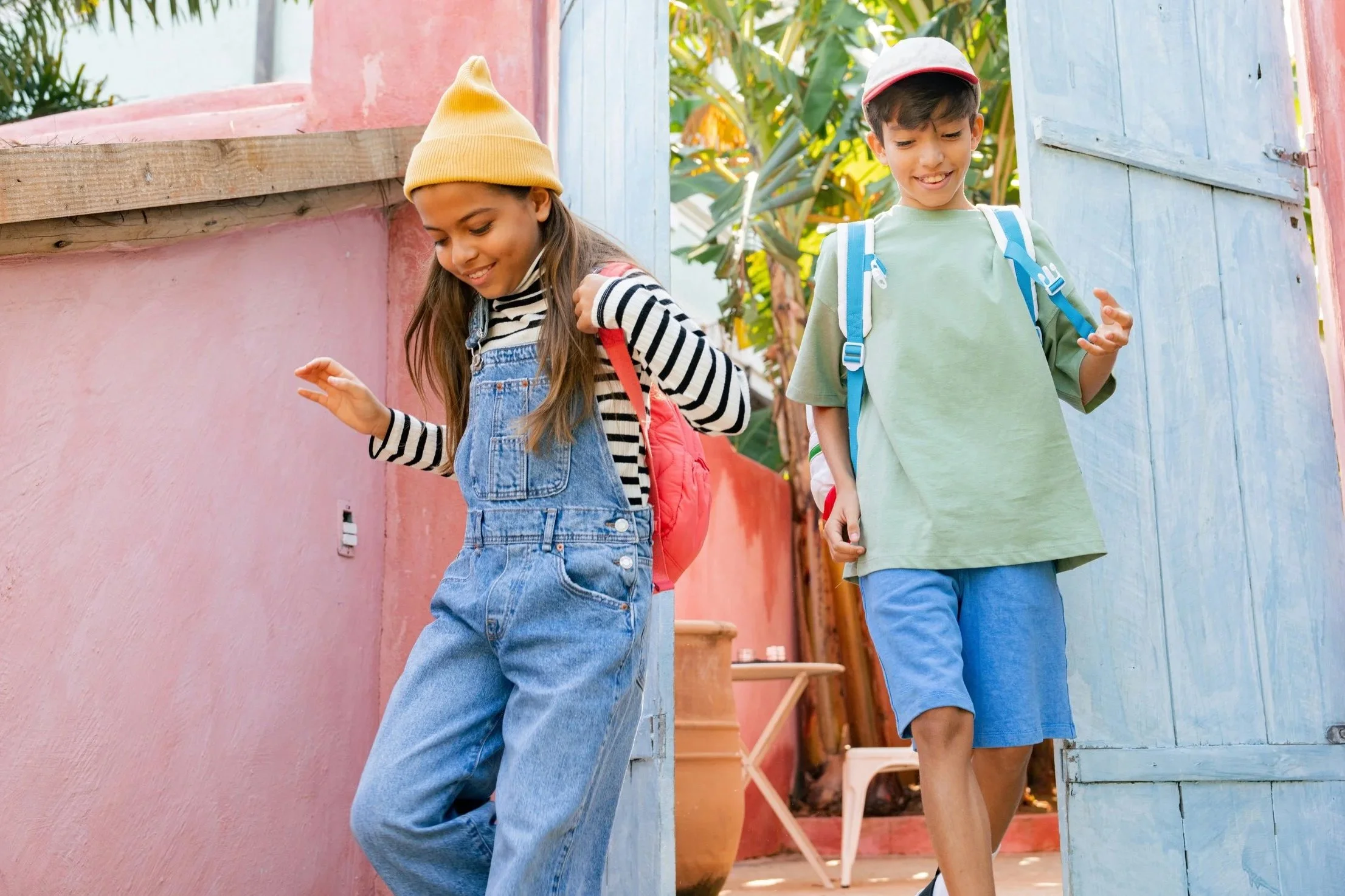 Two children walking together outdoors, capturing everyday moments of childhood.