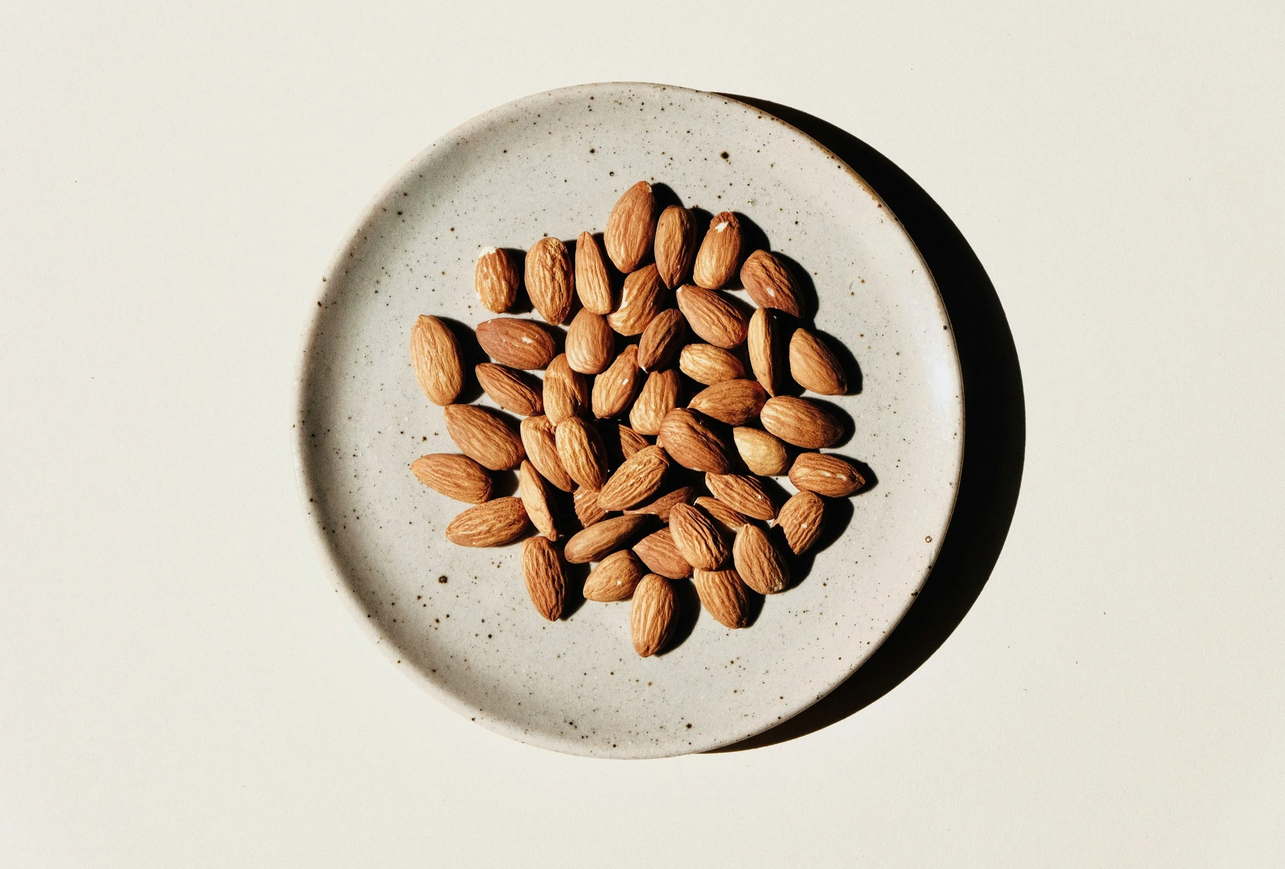 Mixed nuts and seeds in a ceramic bowl as a natural source of protein and healthy fats