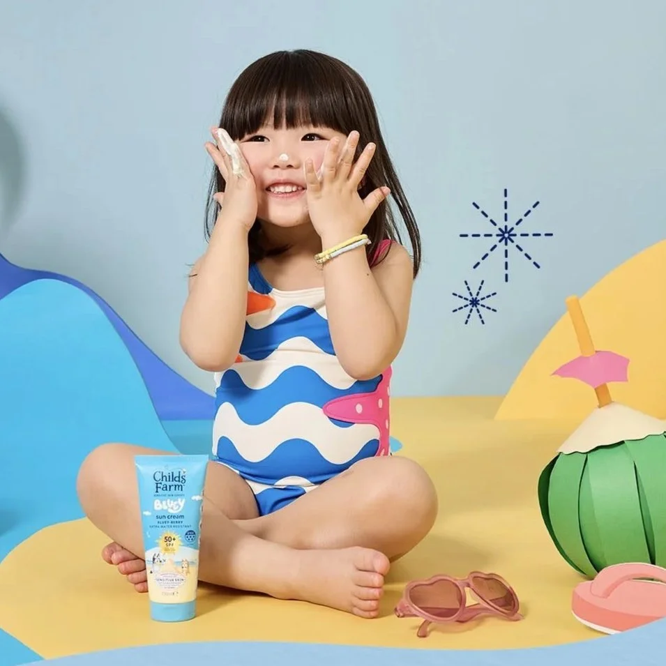 Girl applies Childs Farm's Bluey Sun Cream SPF 50